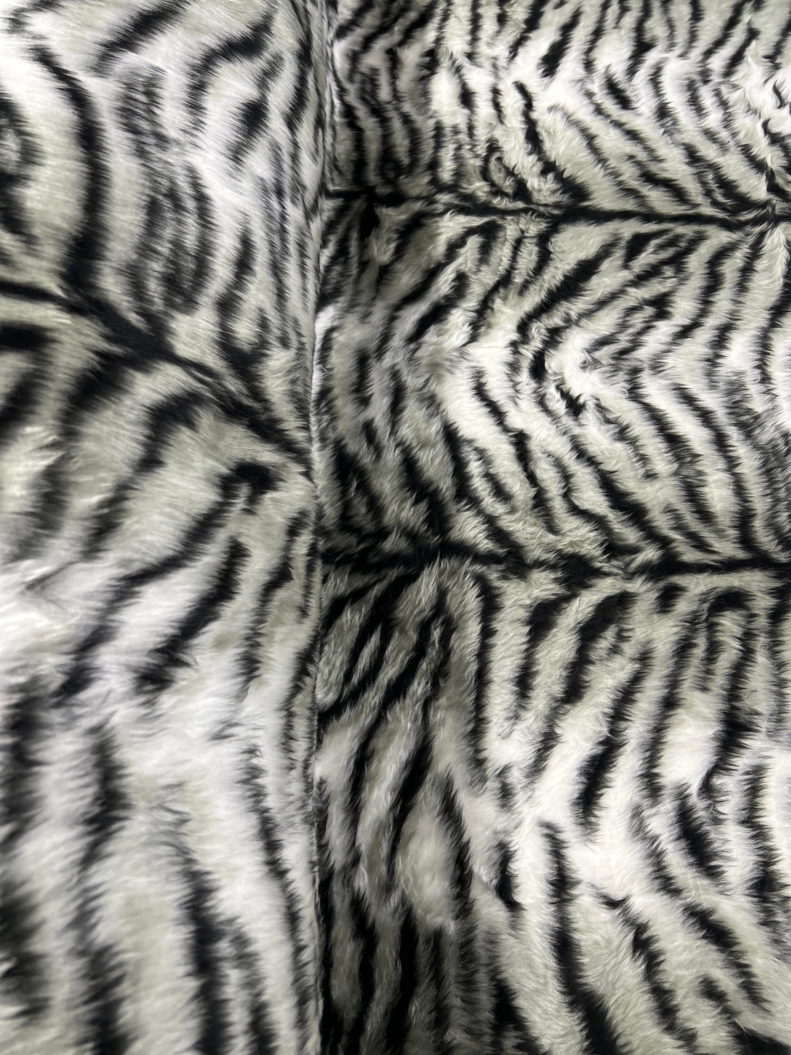 Black & White Snow Tiger Stripe Faux Fur Fabric – snowy white faux fur pile with tapering black tiger stripes