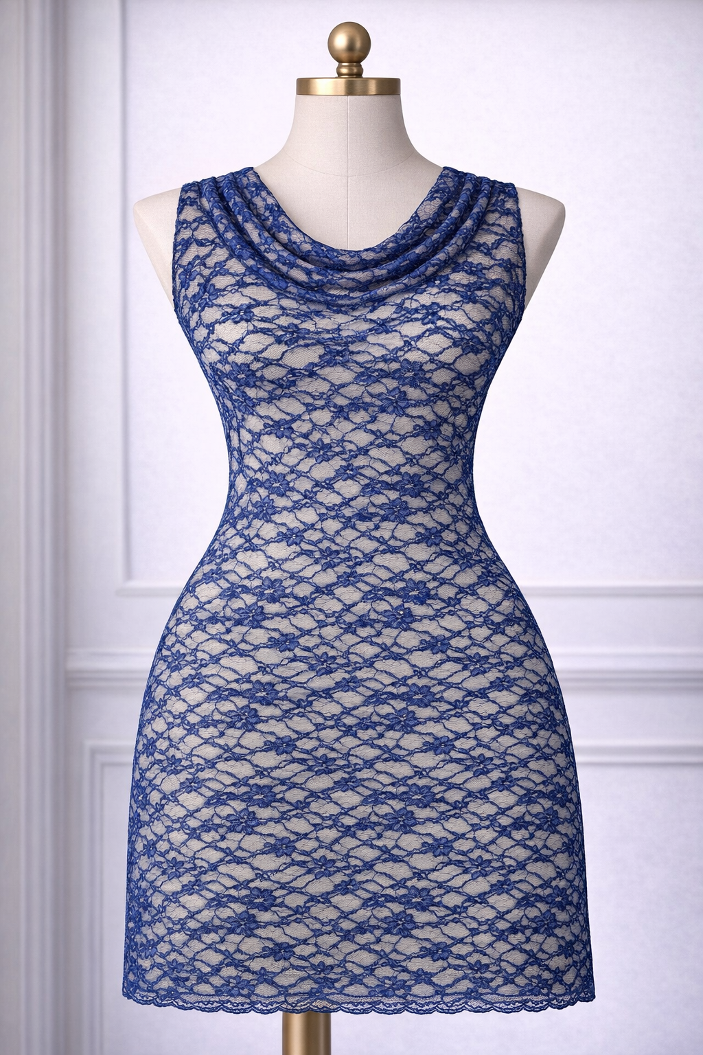 Blue lace dress on a mannequin against a white paneled wall.