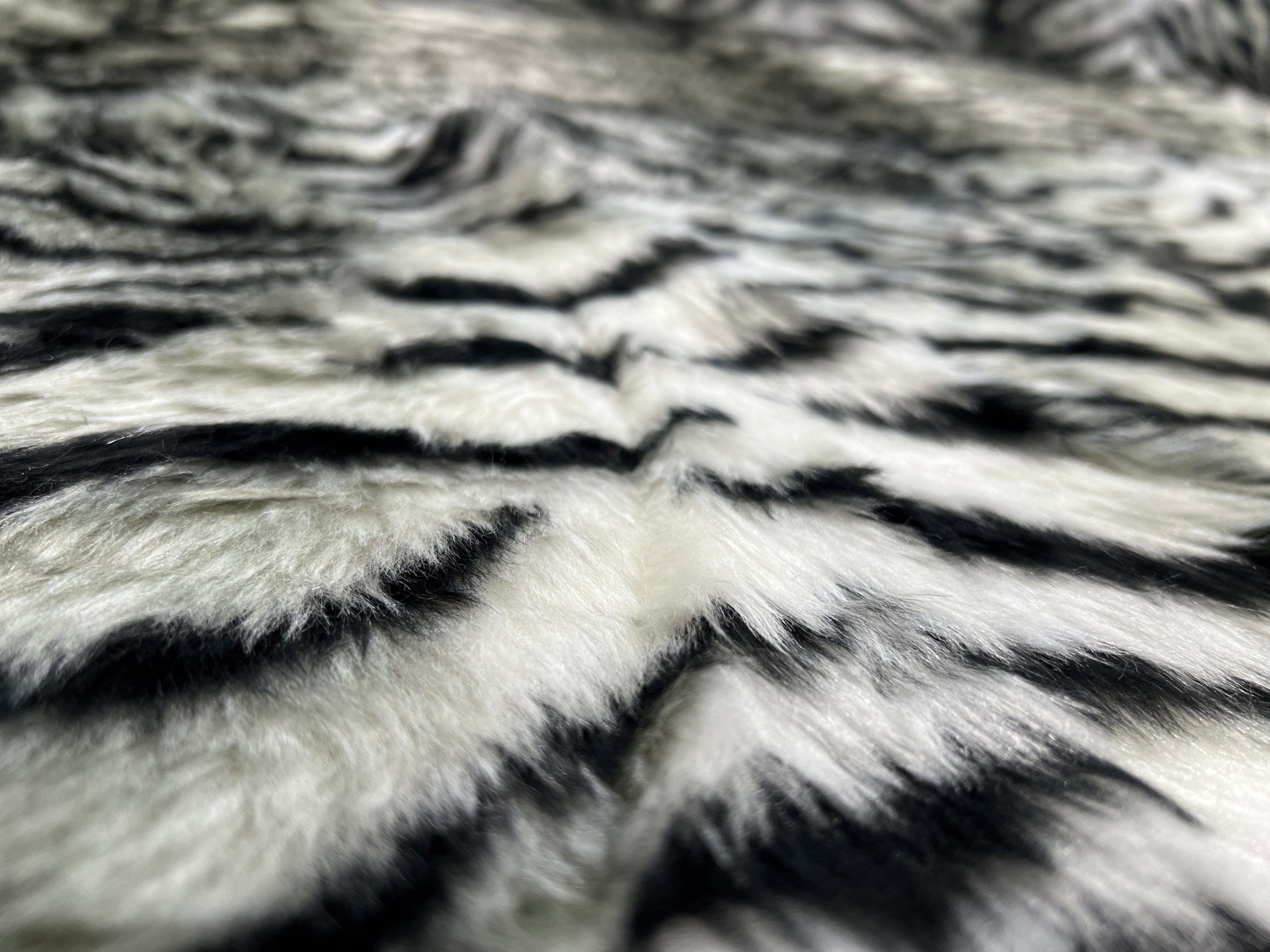 Black & White Snow Tiger Stripe Faux Fur Fabric – snowy white faux fur pile with tapering black tiger stripes