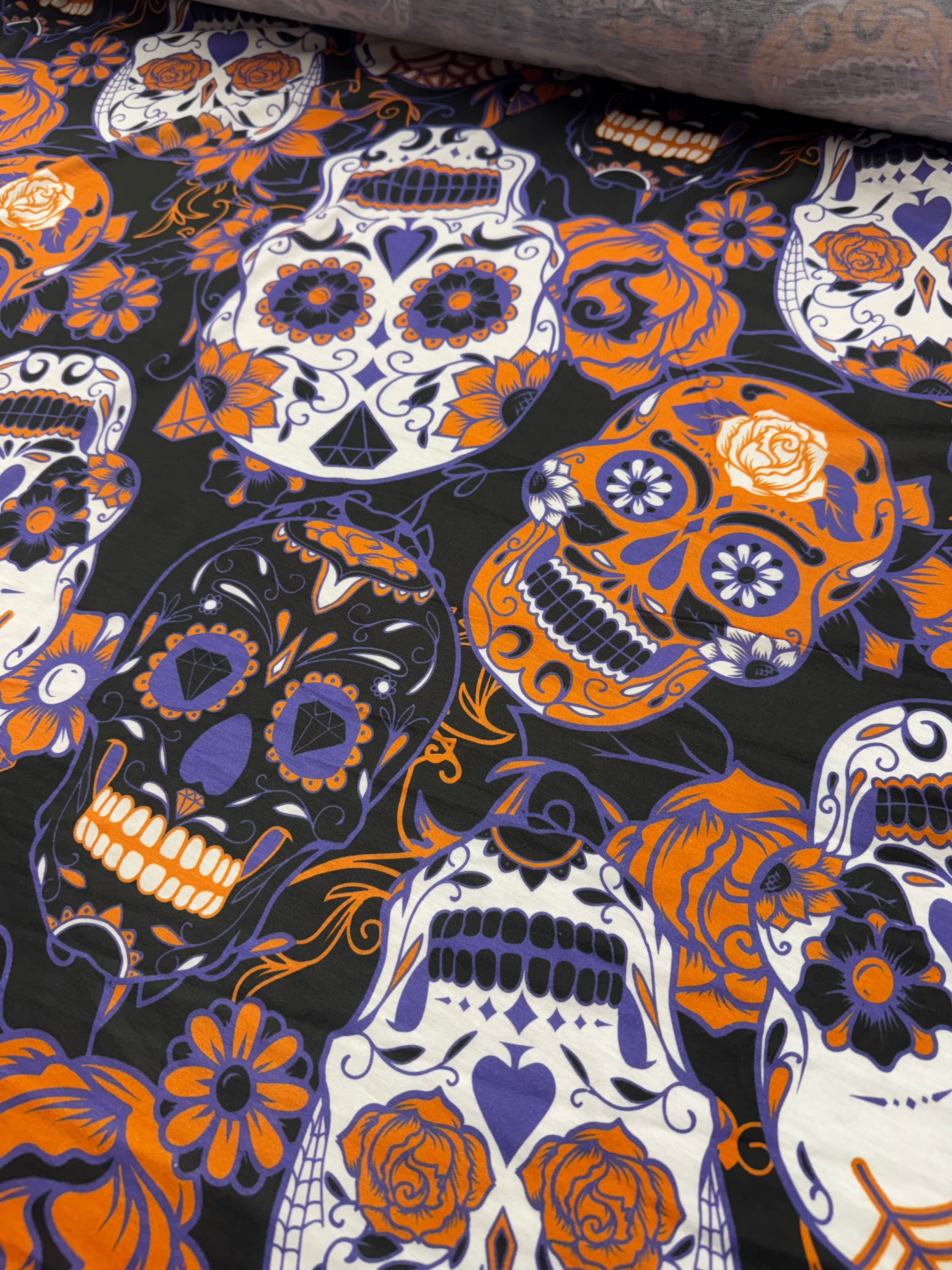 Fabric swatch showing sugar skull design in vivid colors