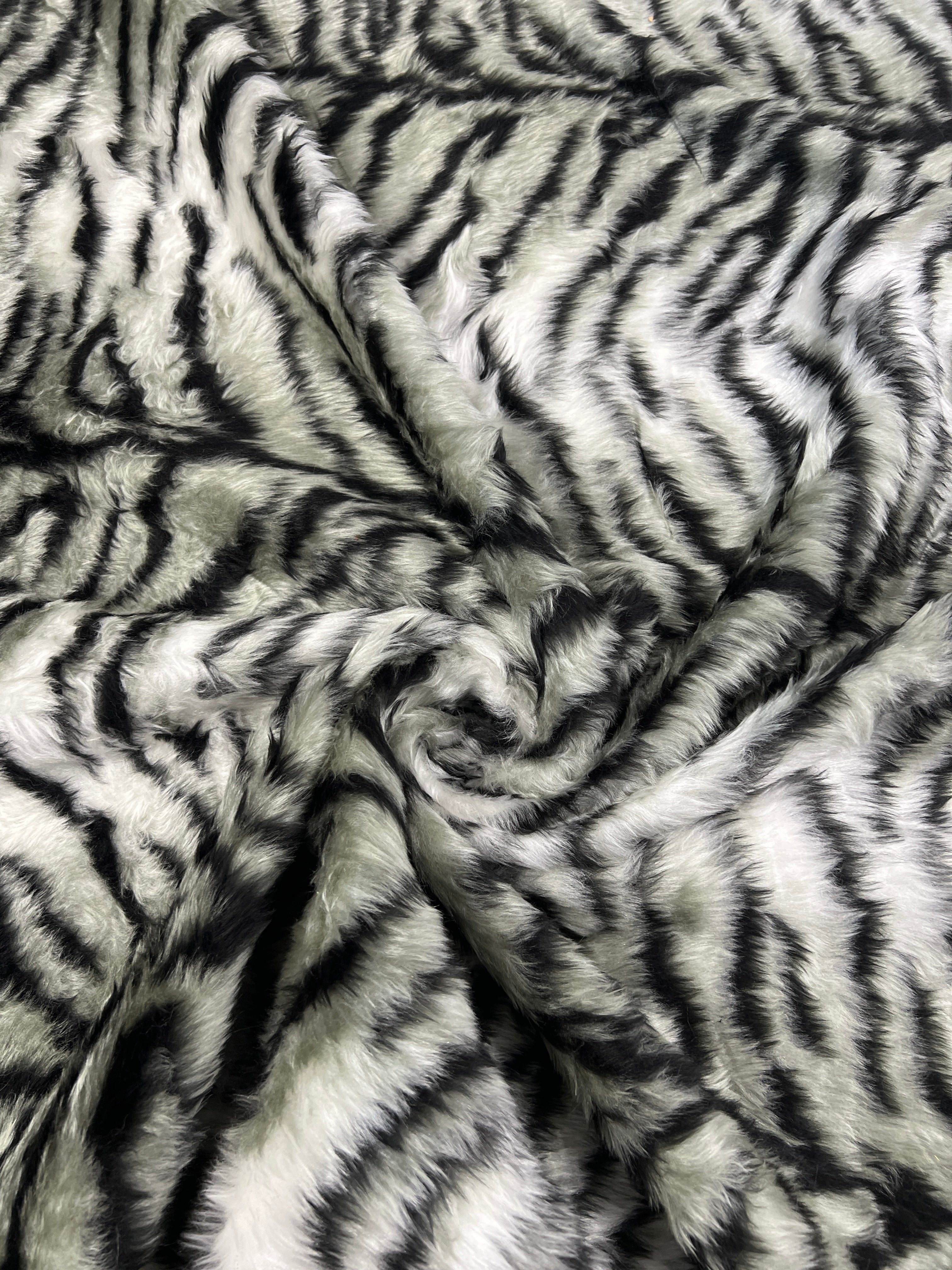 Black & White Snow Tiger Stripe Faux Fur Fabric – snowy white faux fur pile with tapering black tiger stripes