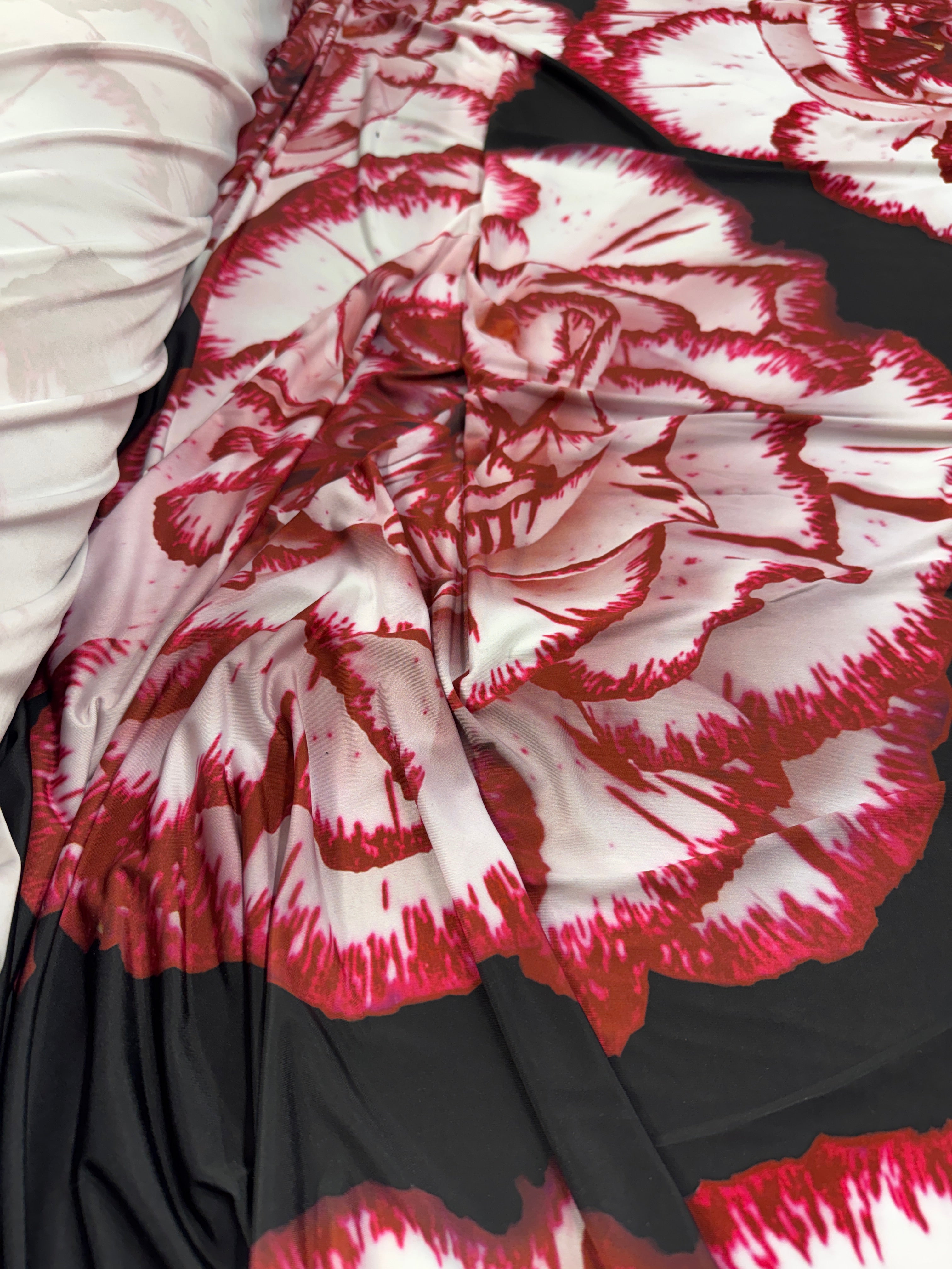 Close-up of black and red floral fabric showing rose details