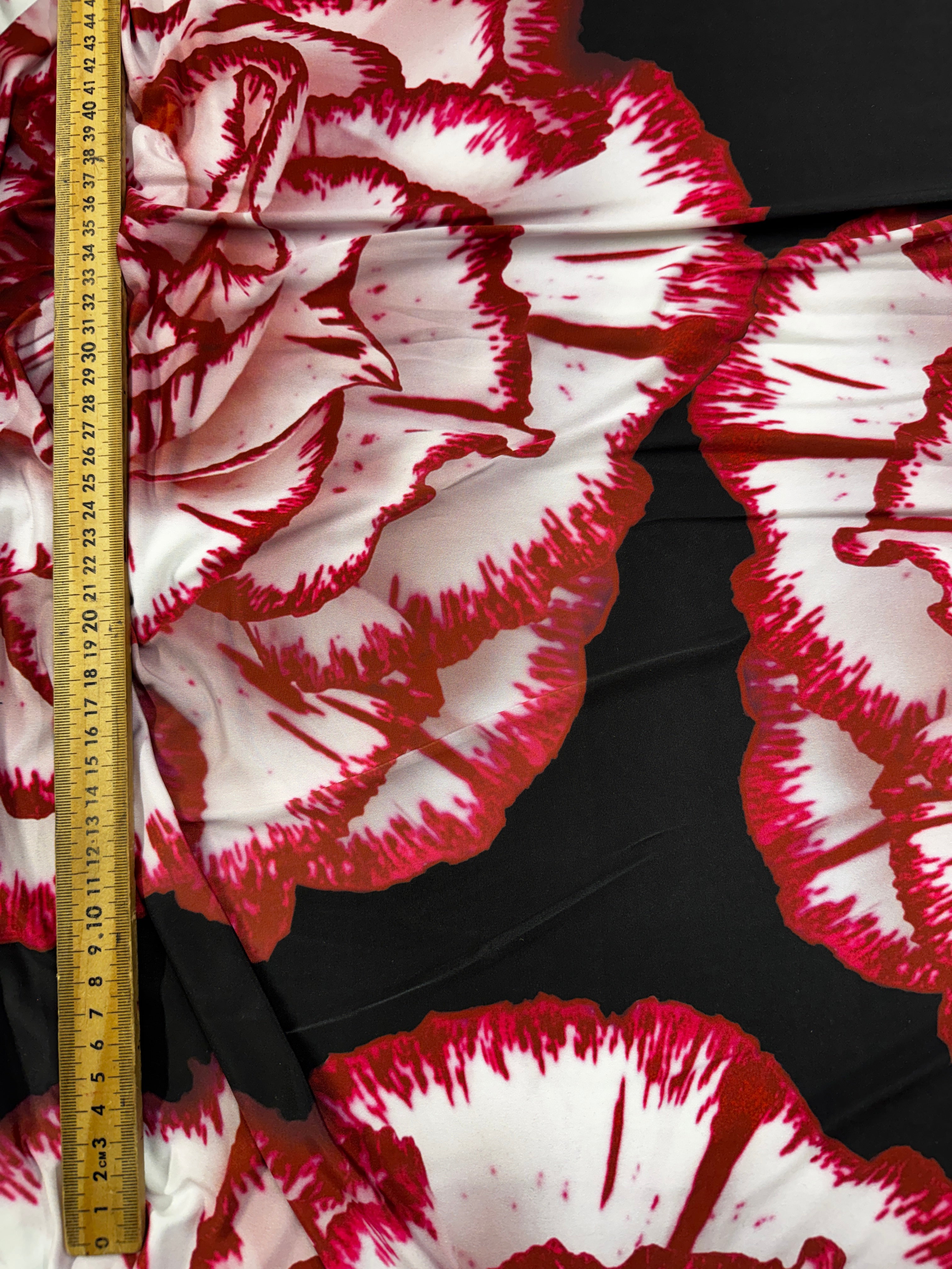 Fluid drape of black and red floral fabric on display