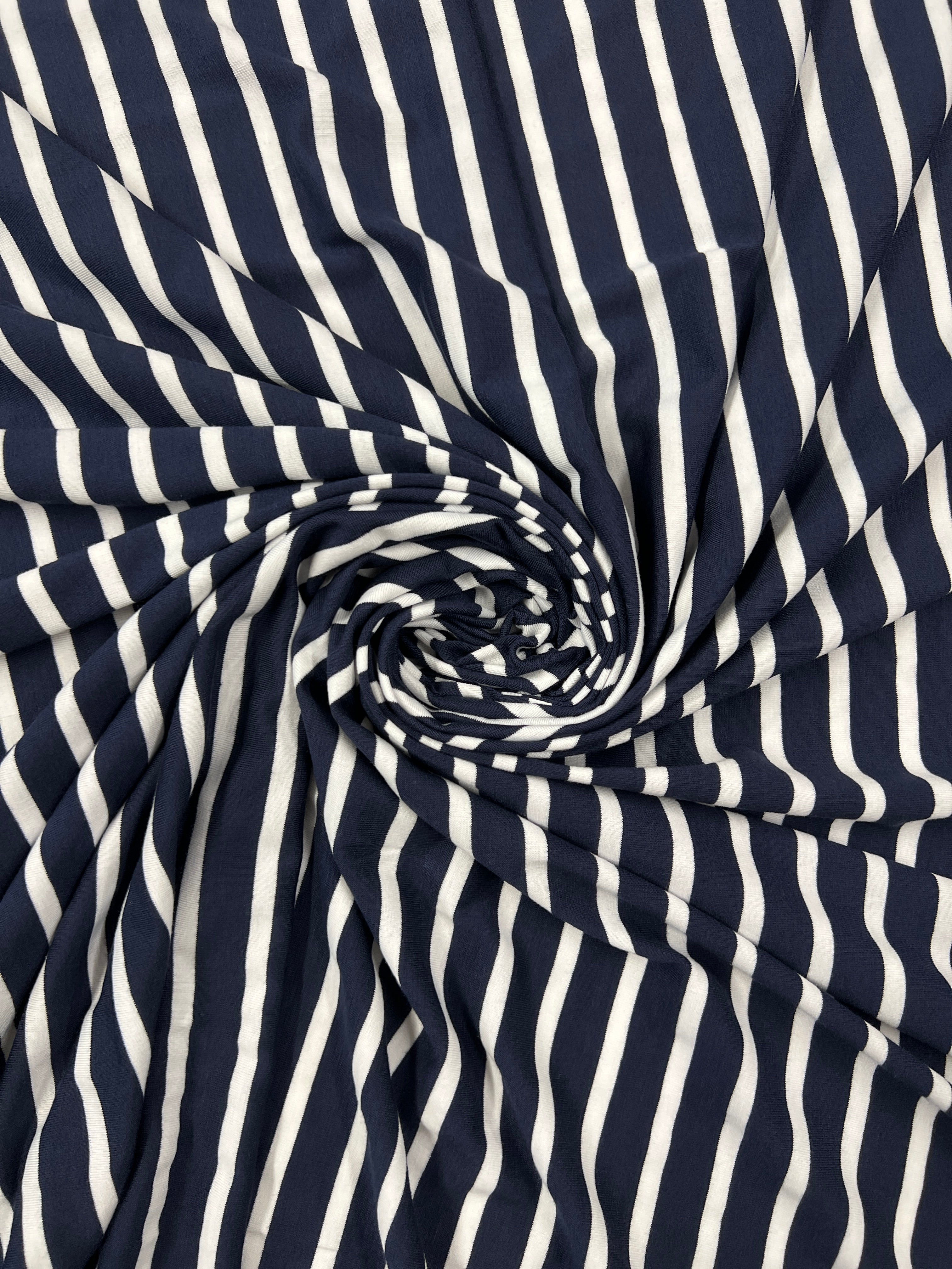 Navy and white striped fabric in a swirl pattern
