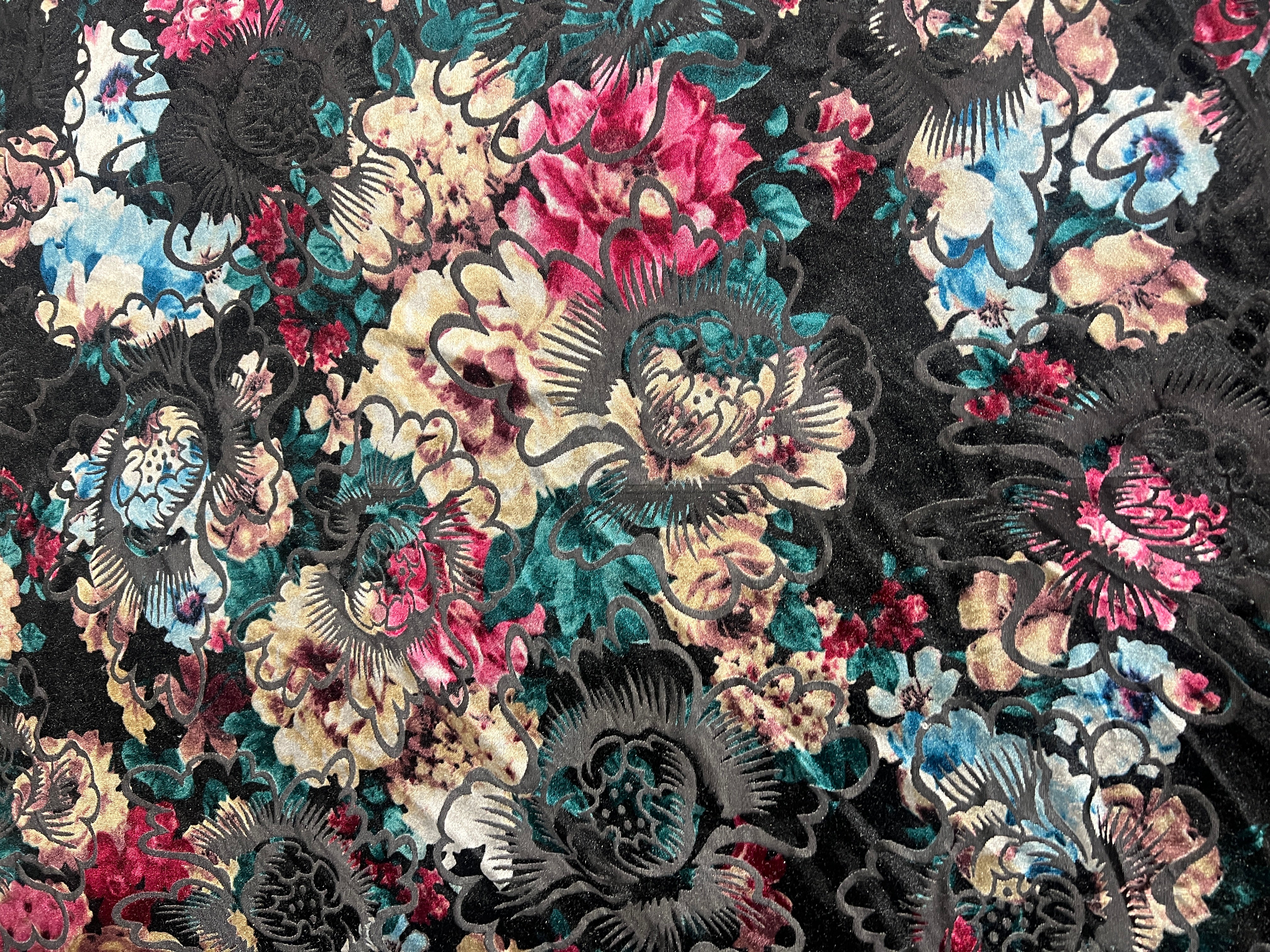Close-up of a floral pattern with vibrant colors on a black background