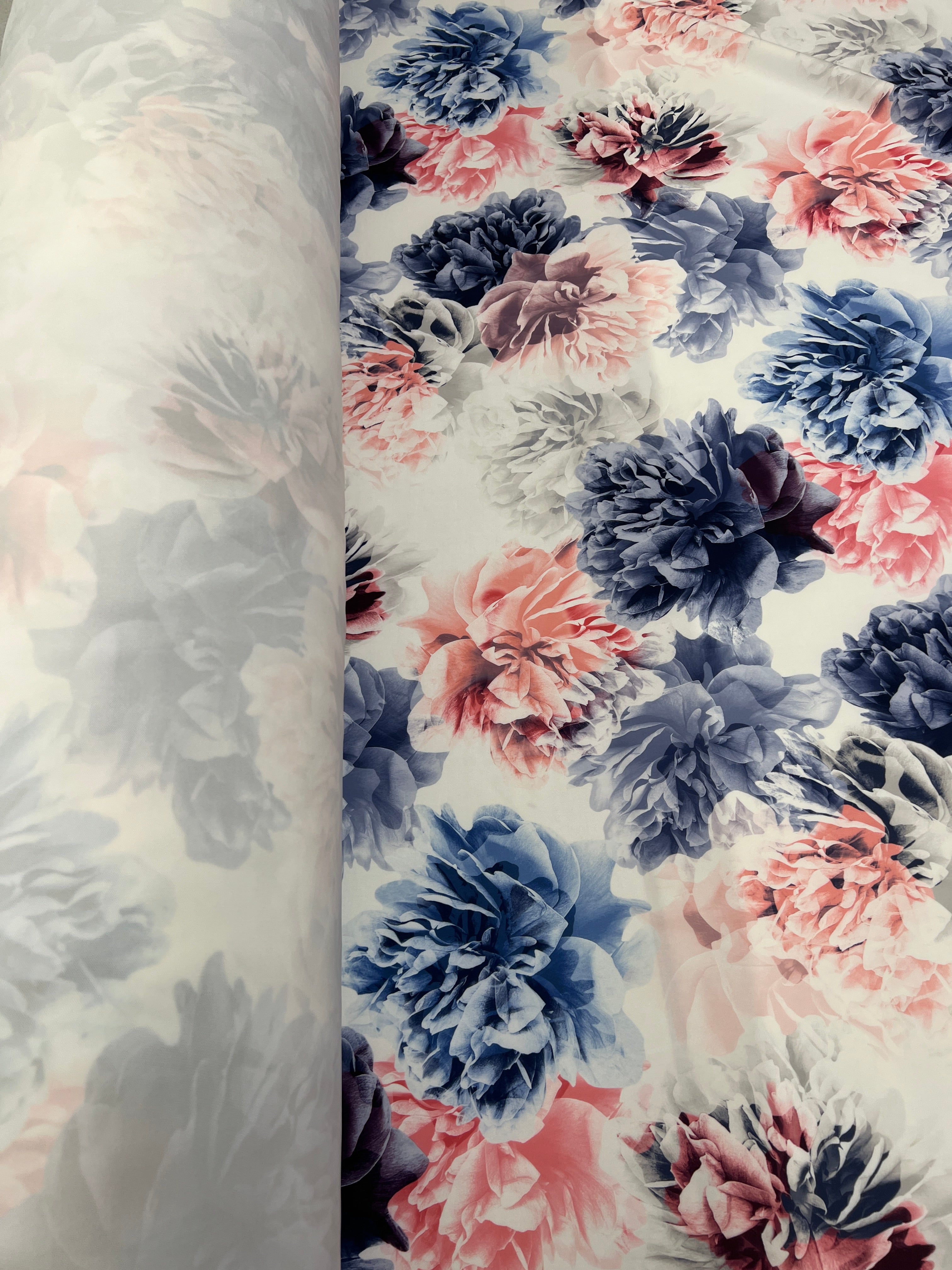 Floral patterned fabric with pink and blue flowers on a white background