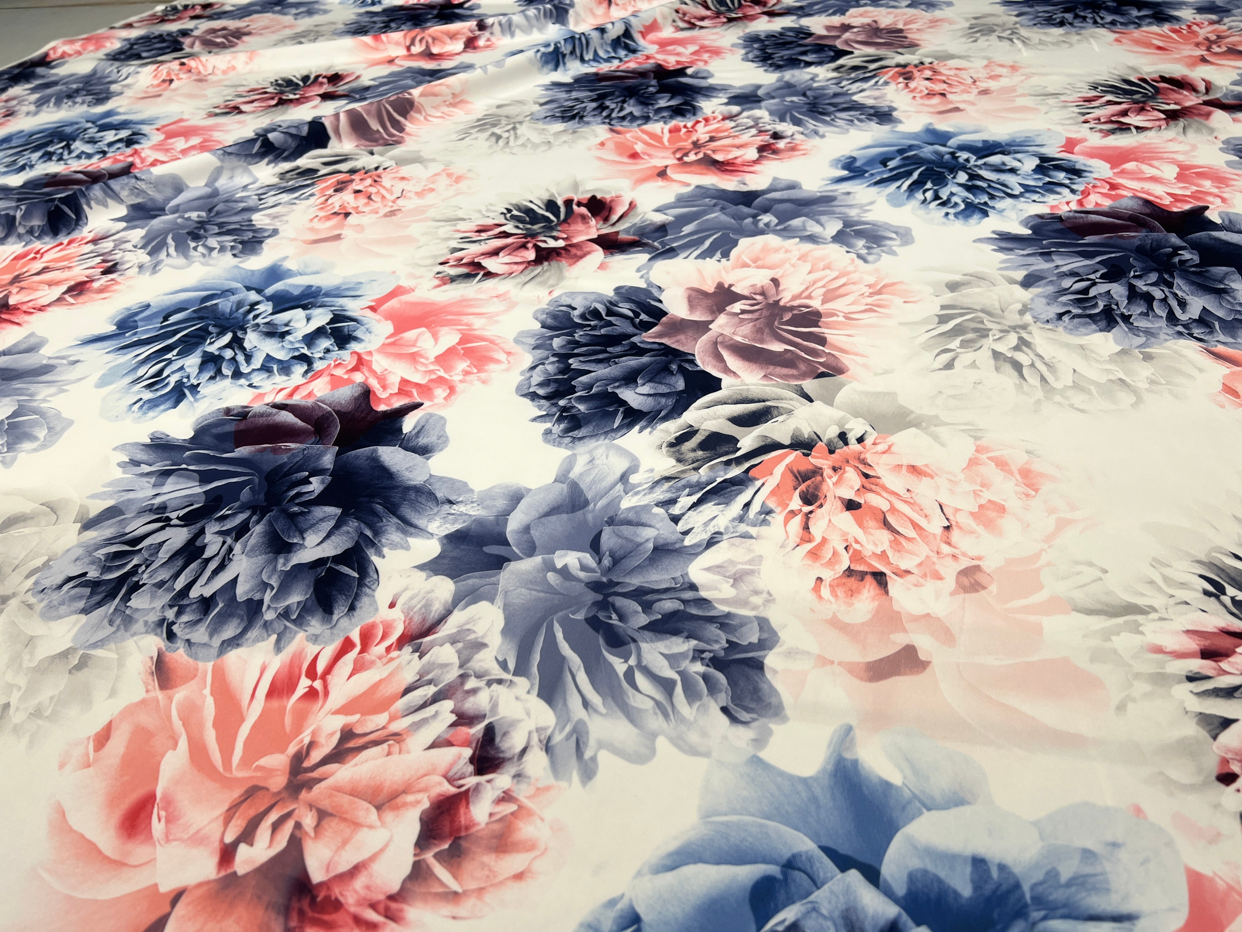 Floral fabric with pink and blue flowers on a white background