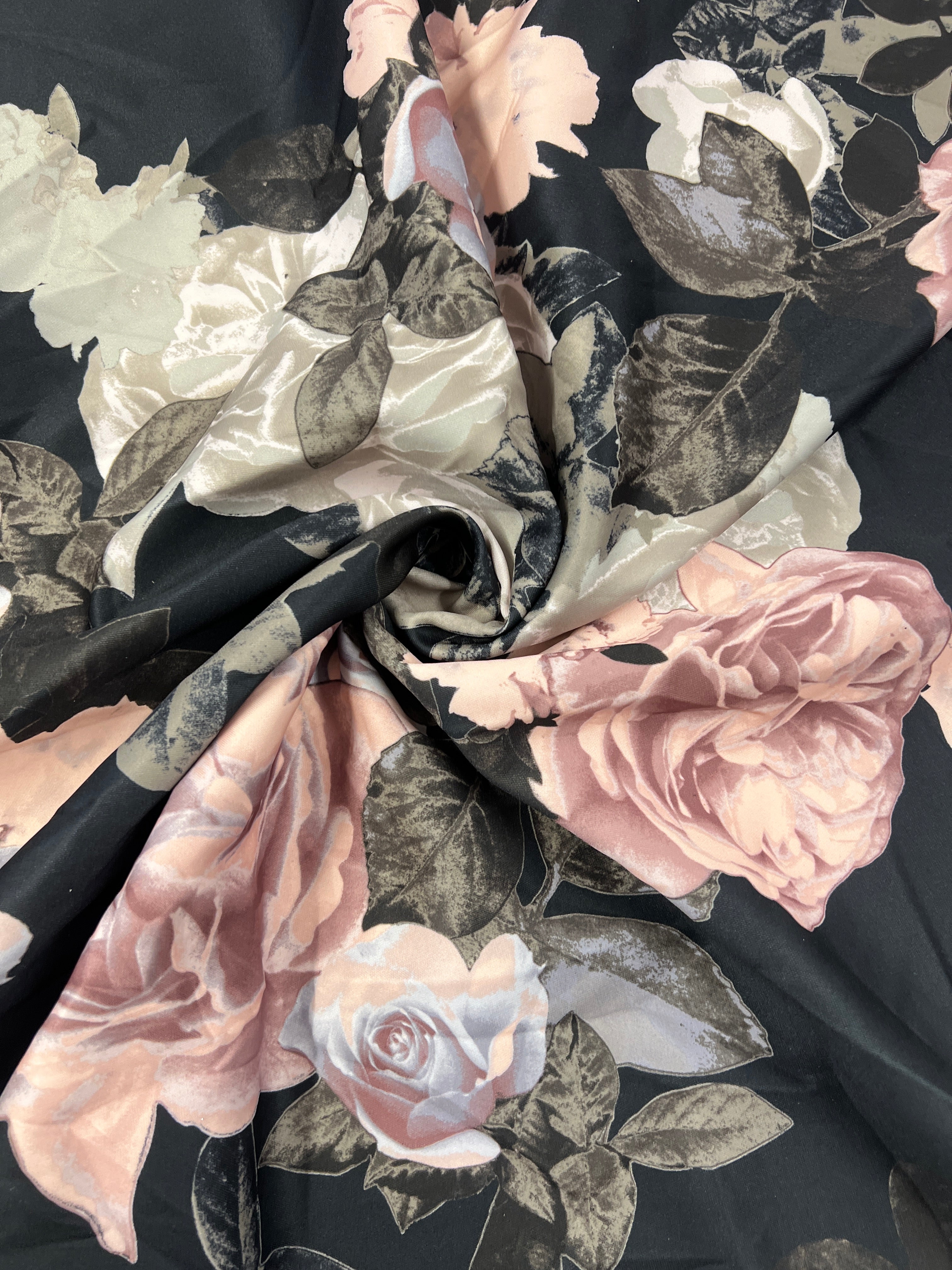 Floral fabric with pink and white roses on a black background