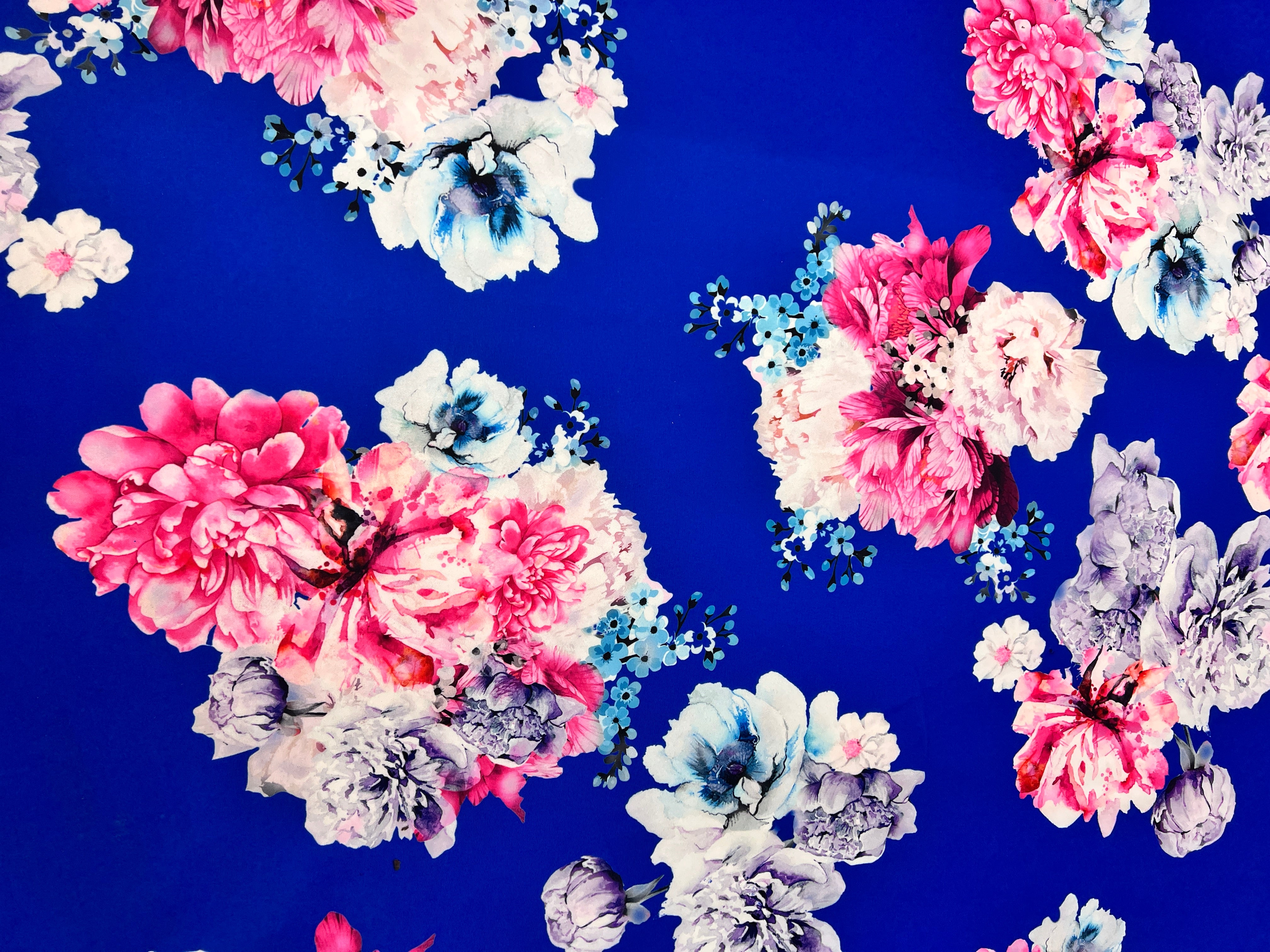 Floral pattern with pink, blue, and white flowers on a blue background