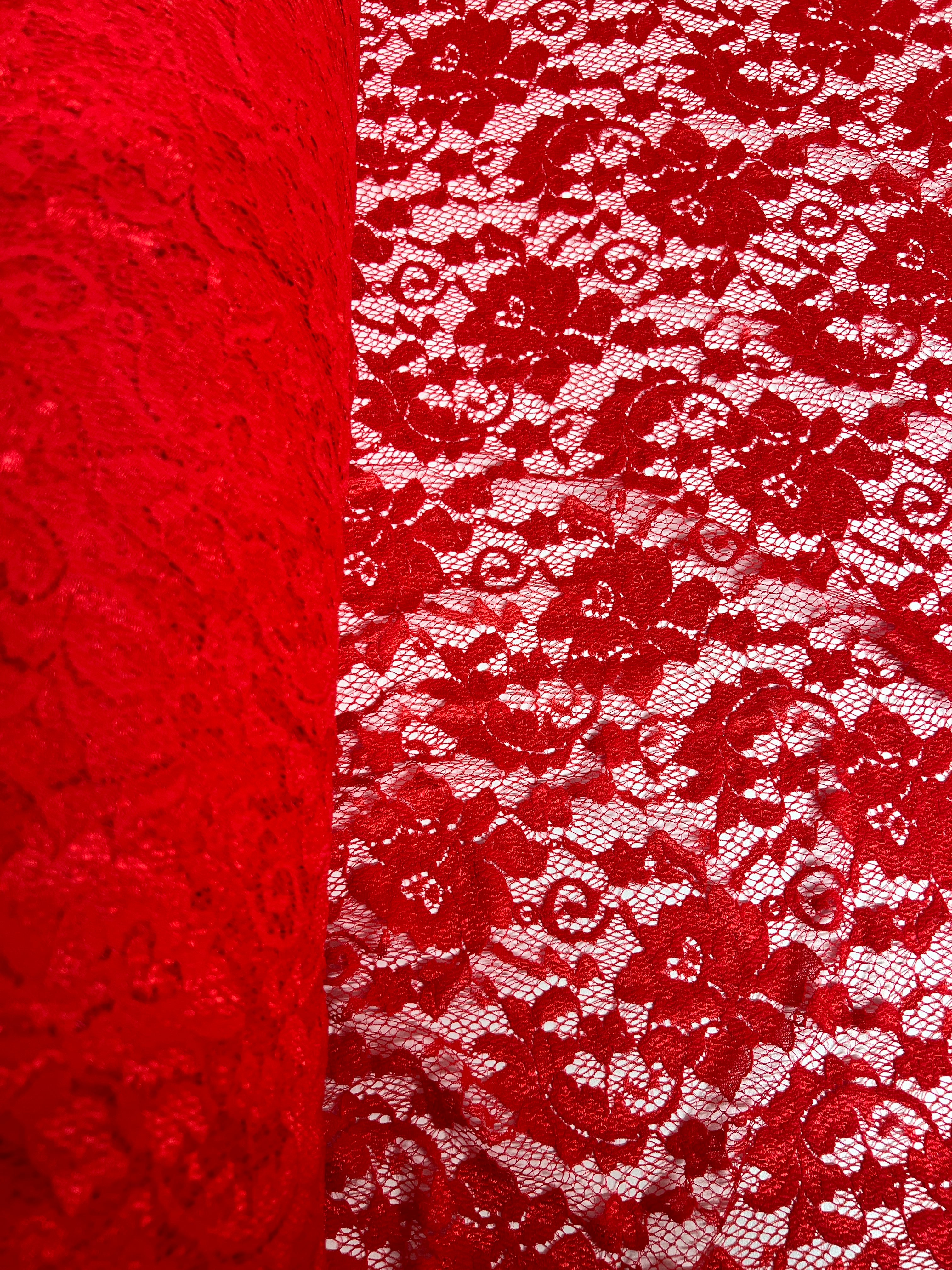 Close-up of red lace fabric with floral patterns