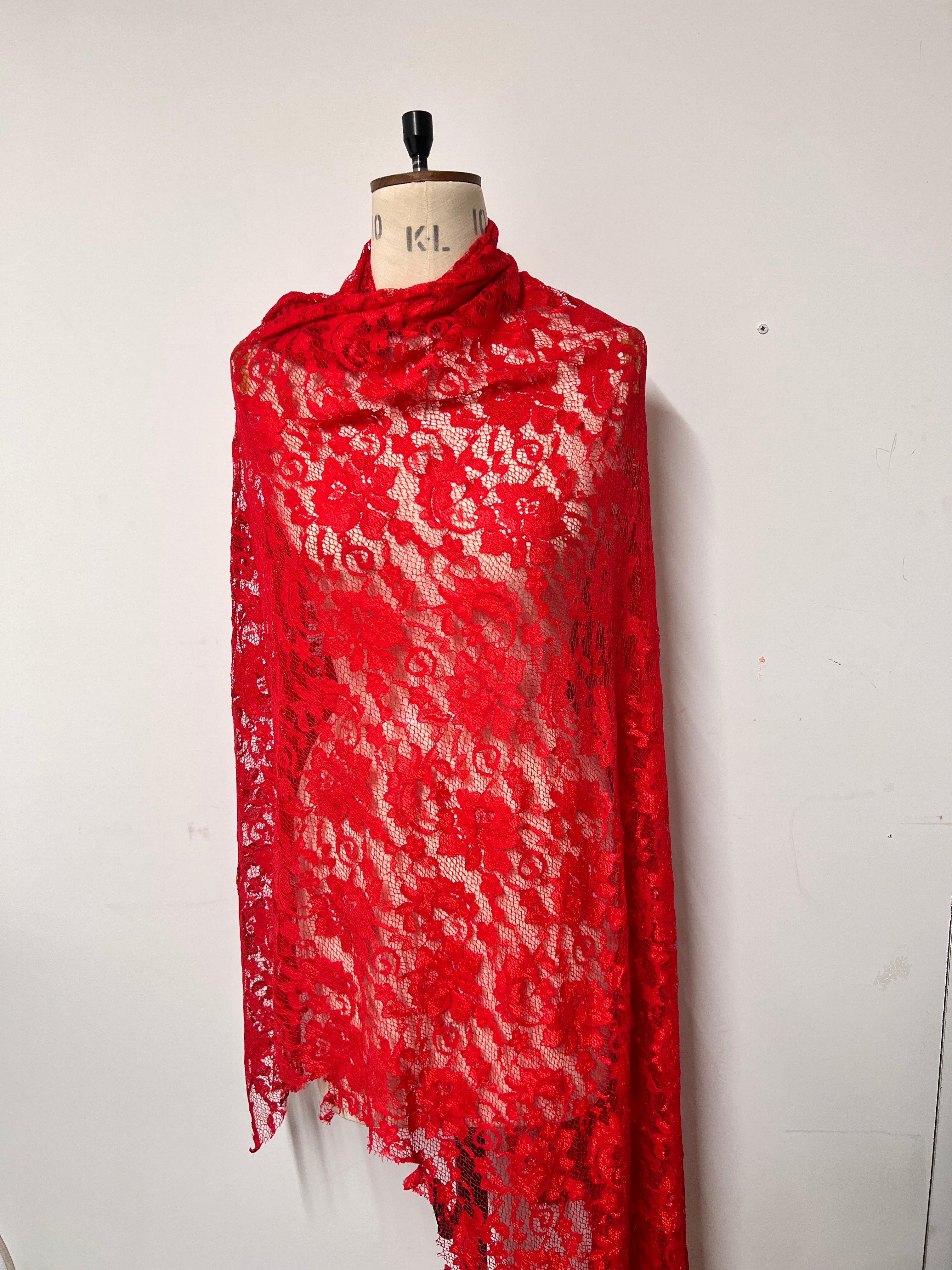 Red lace fabric on a white background