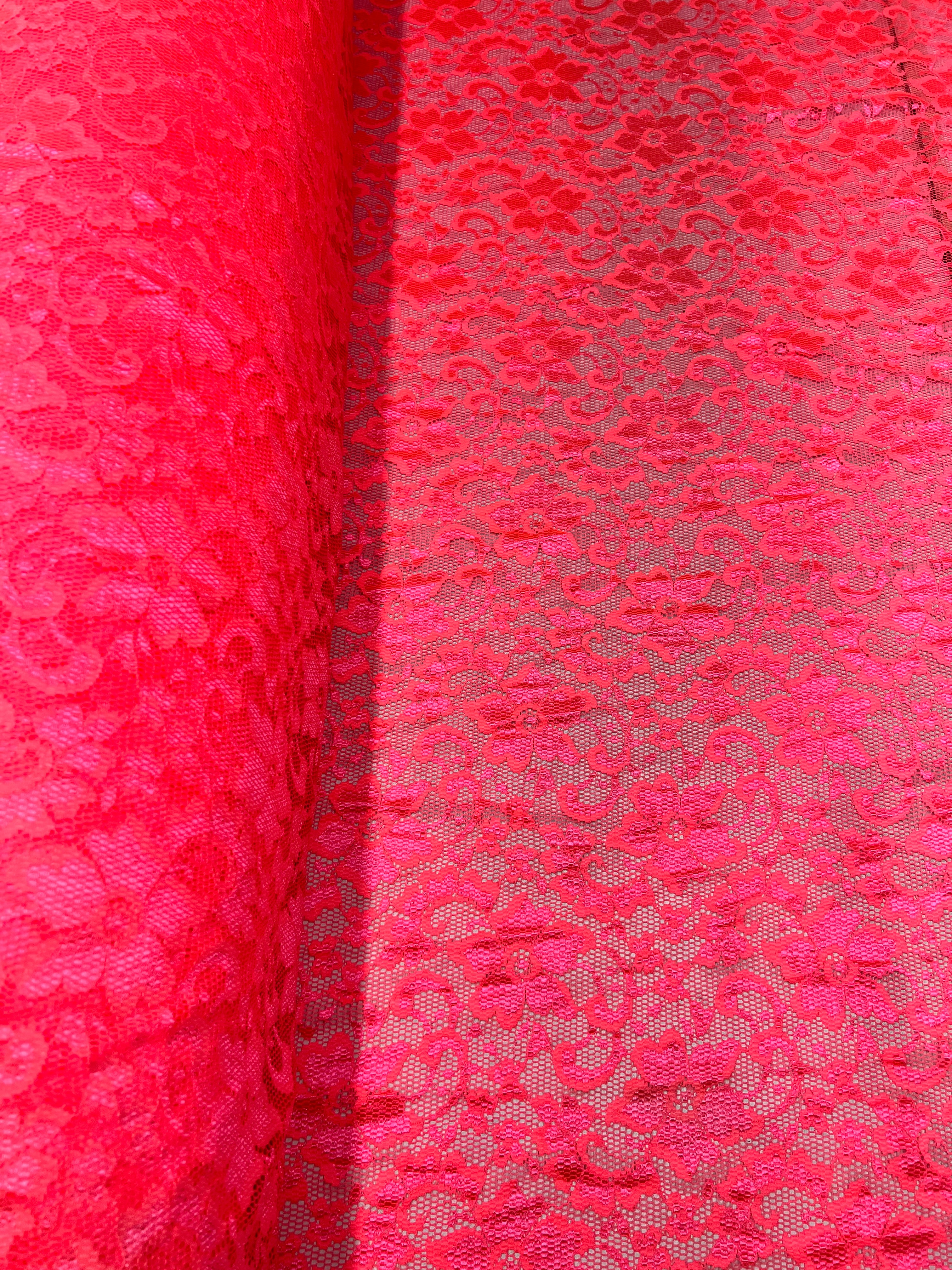 Close-up of red lace fabric with a floral pattern