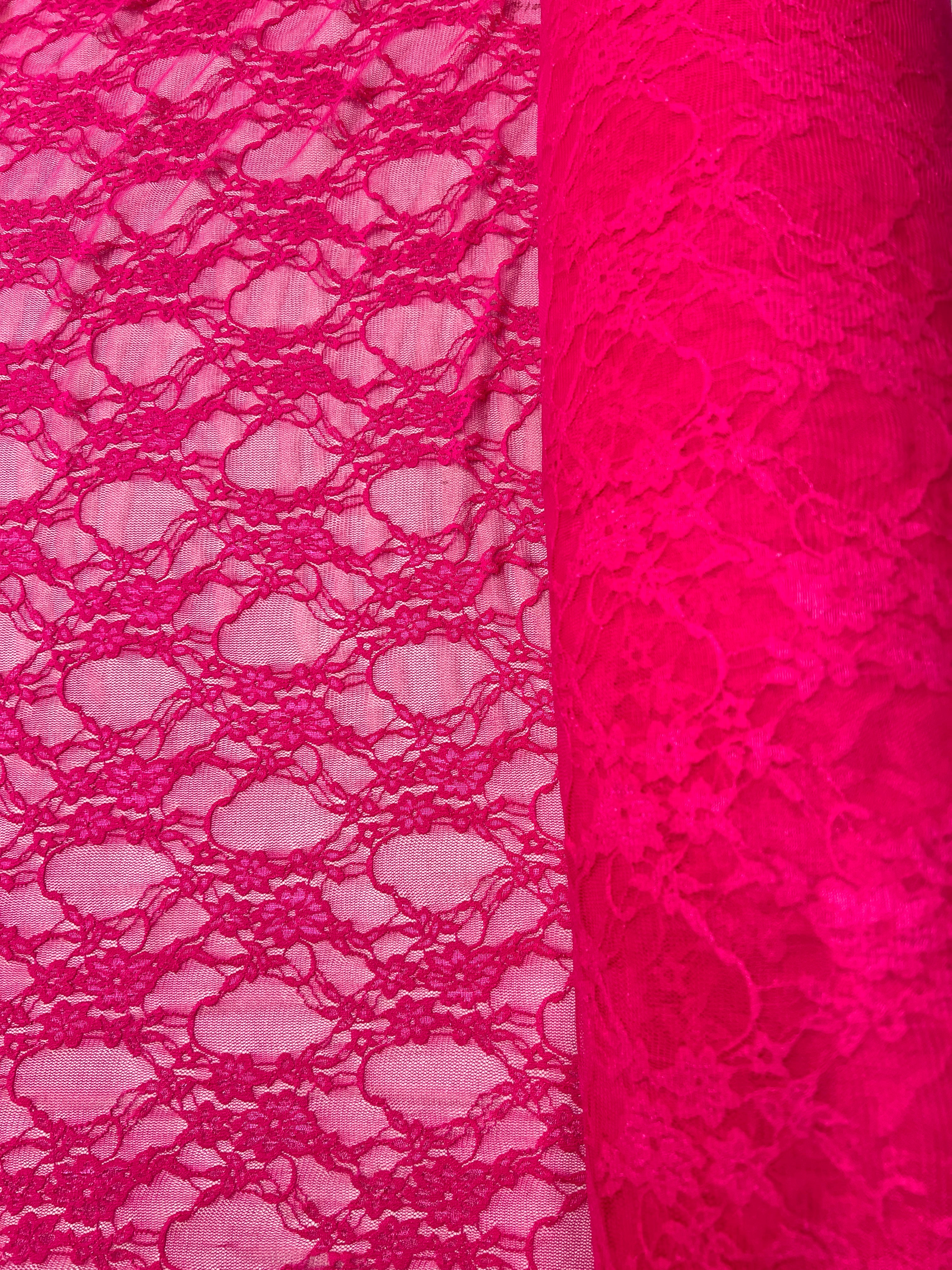 Close-up of pink lace fabric with a detailed pattern