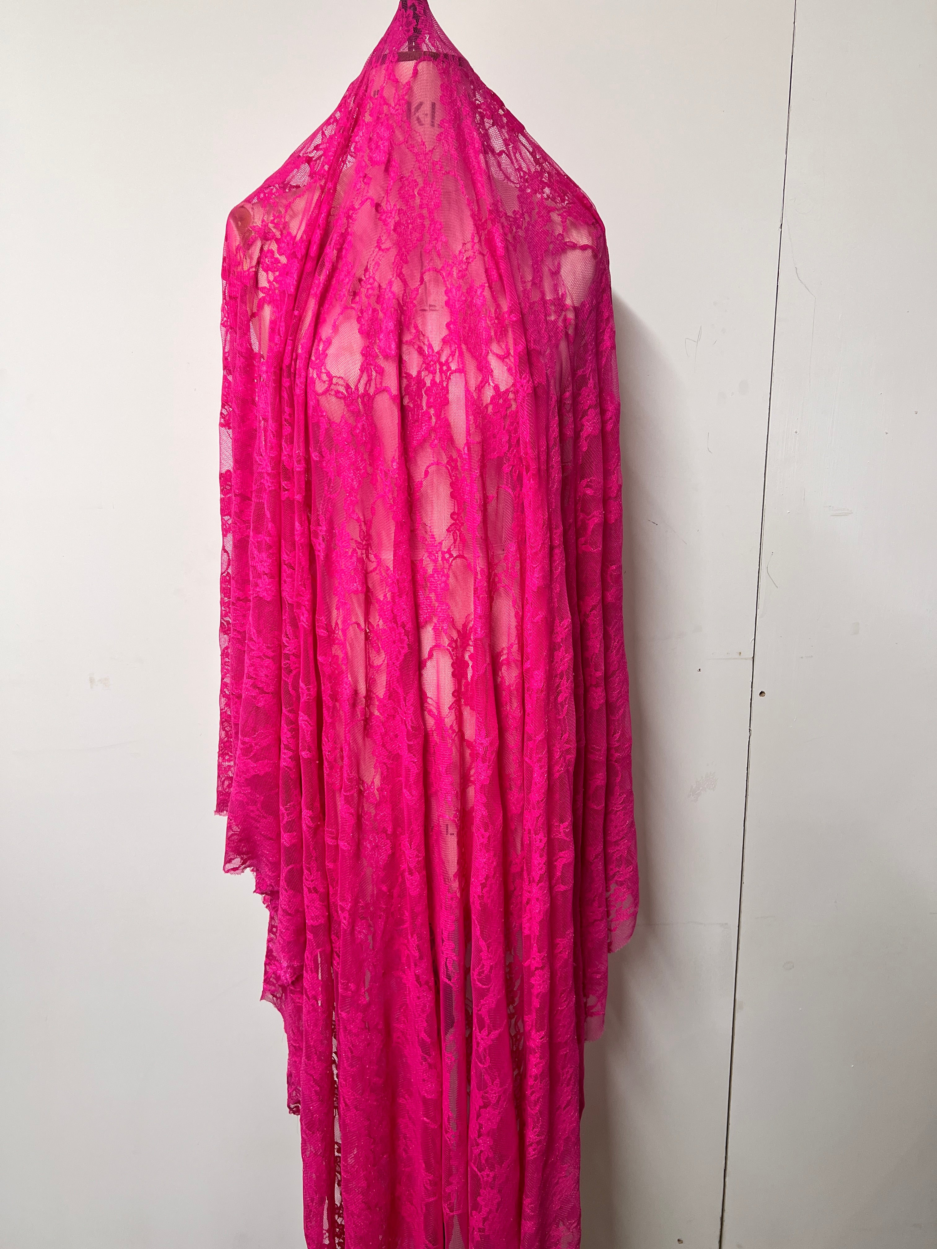 Pink fabric with a floral pattern on a white background