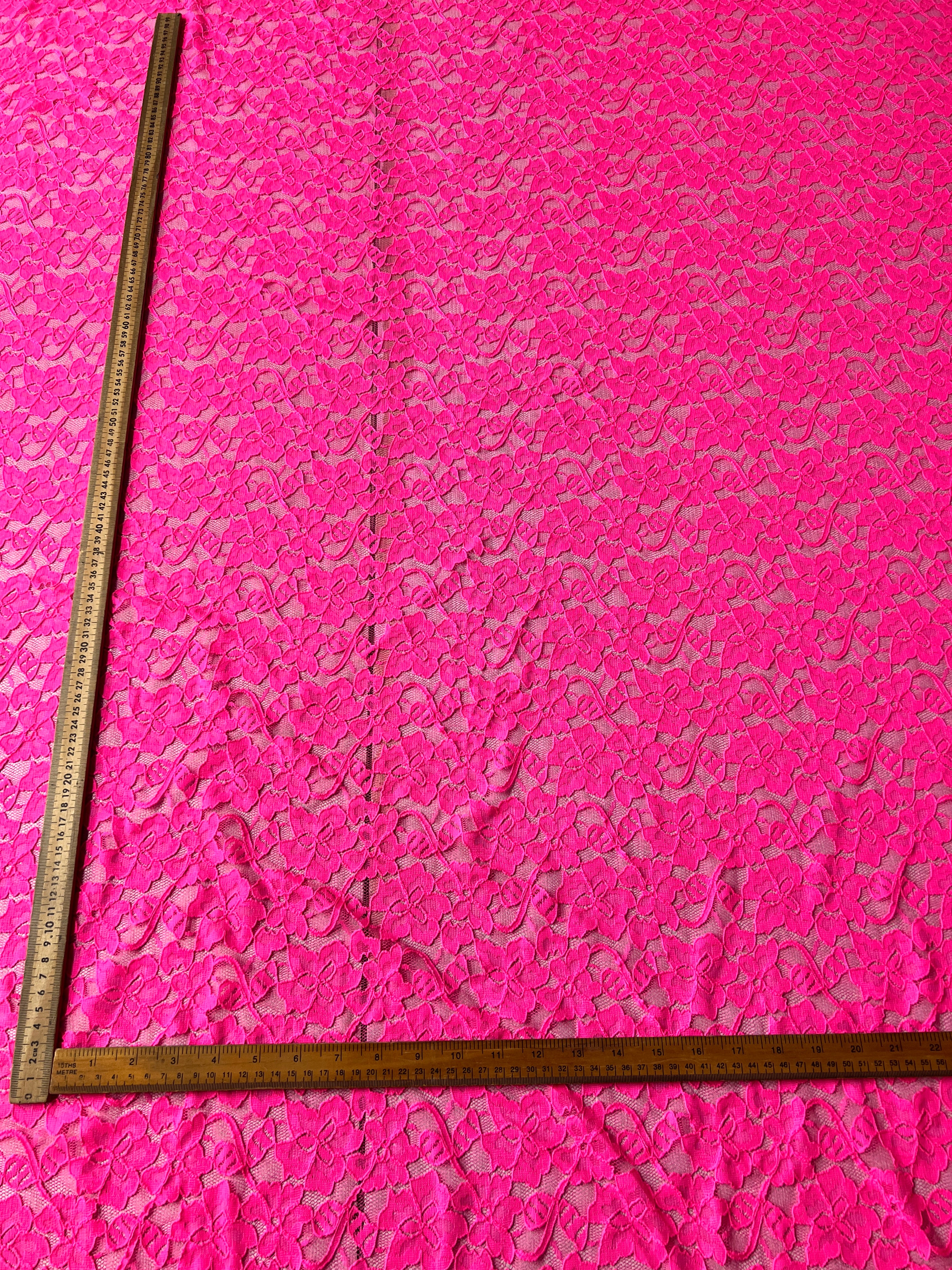 Pink textured fabric with a ruler for scale