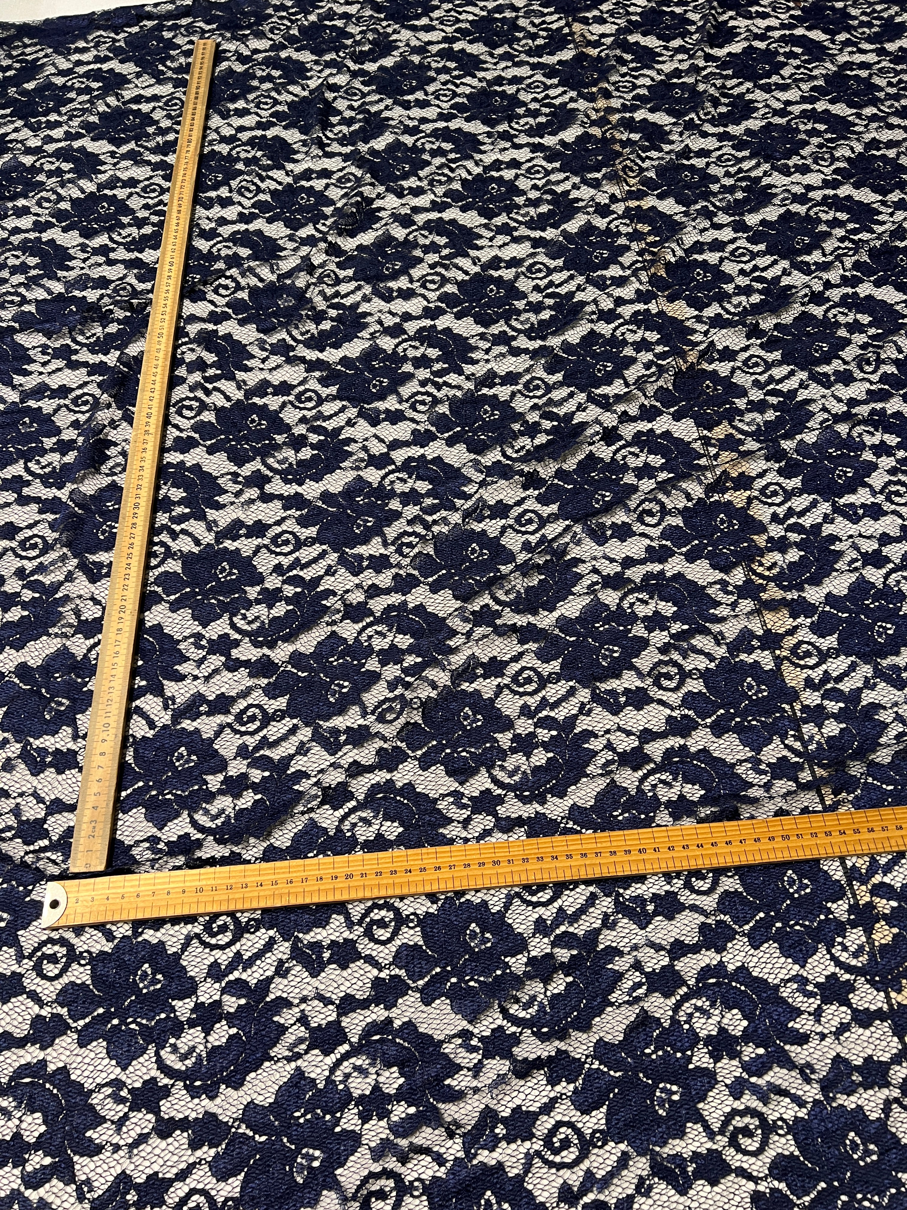 Navy floral patterned fabric with a ruler for scale