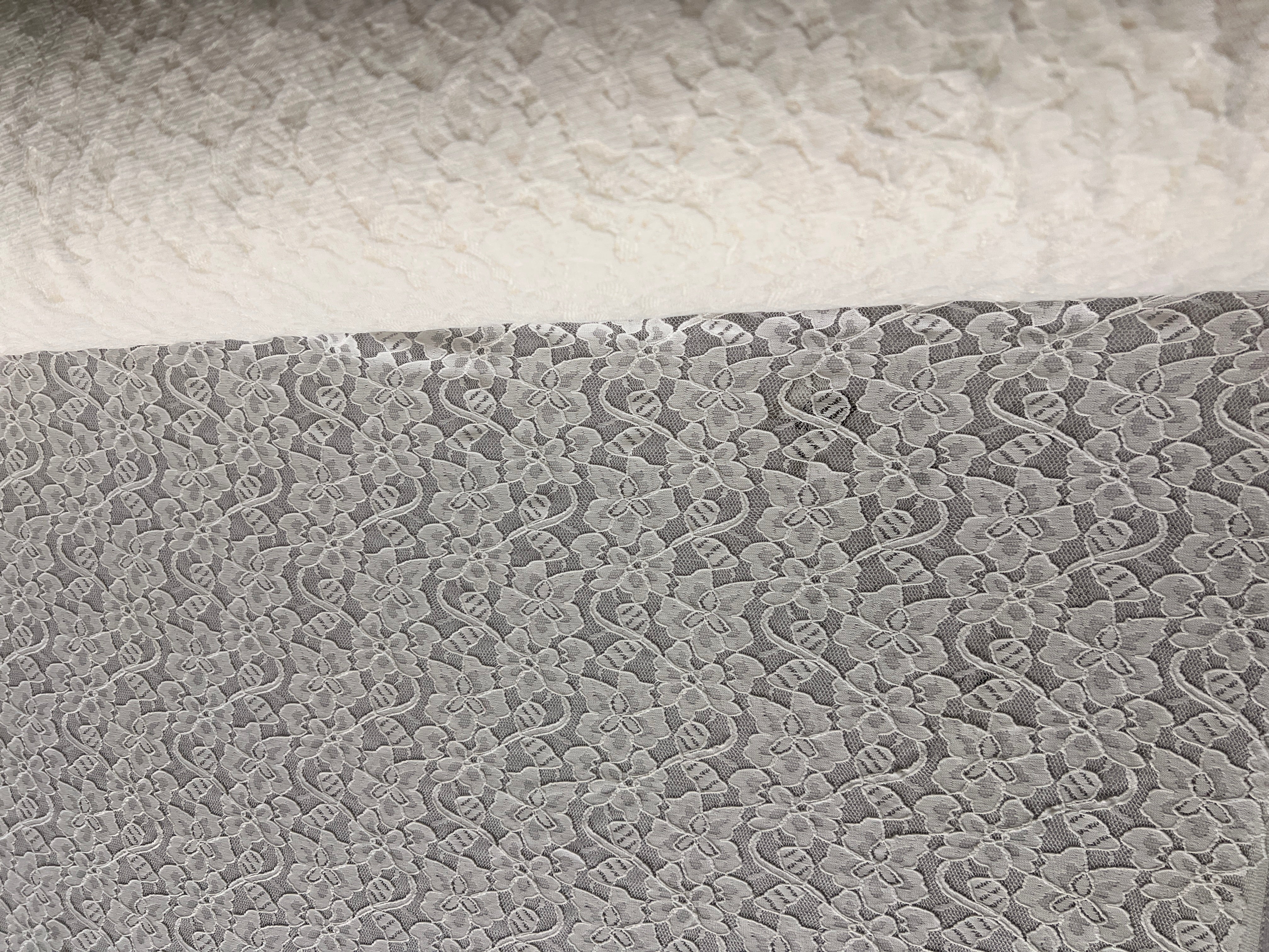 Close-up of textured white fabric with a subtle pattern