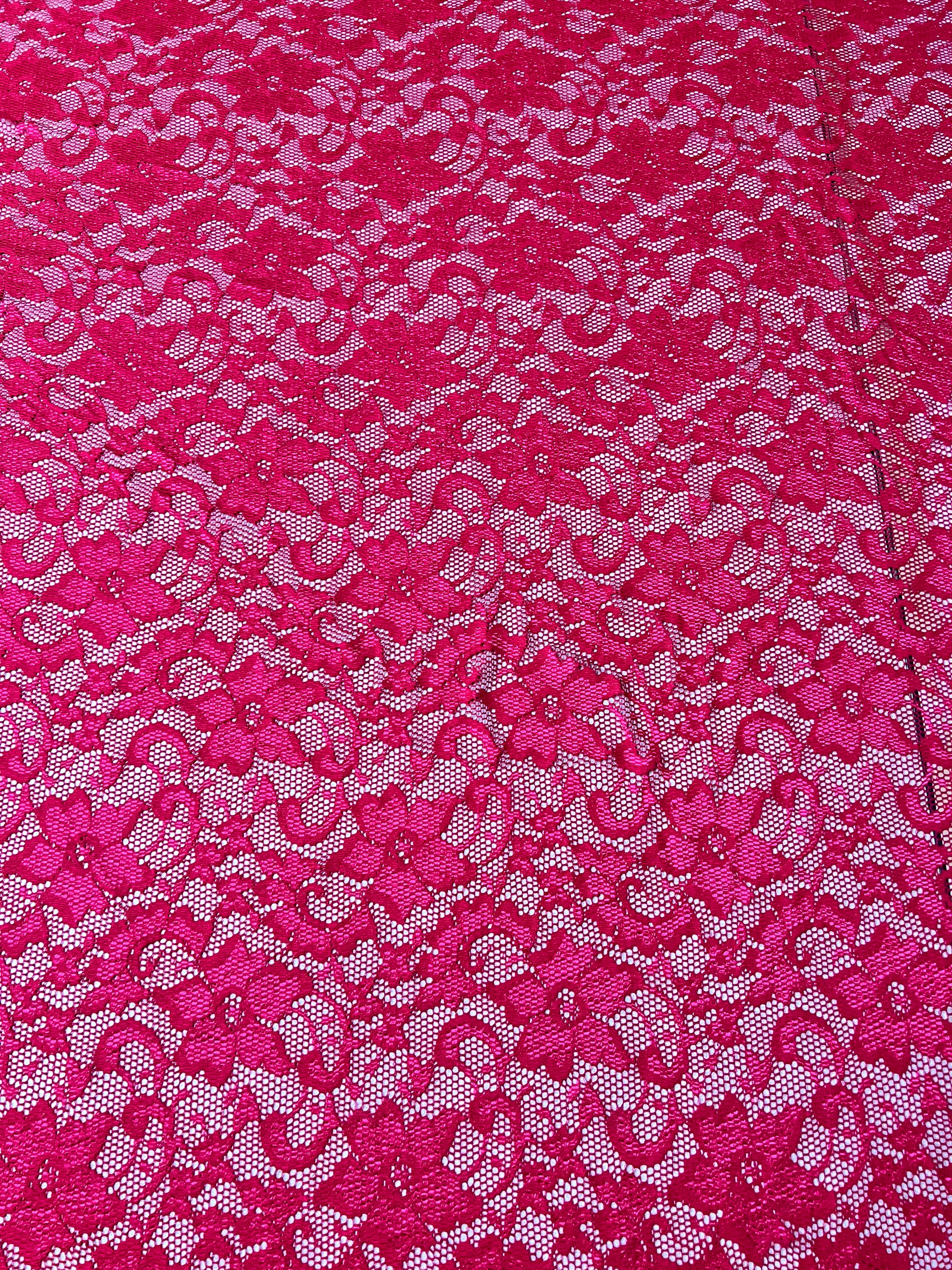 Close-up of pink lace fabric with a floral pattern