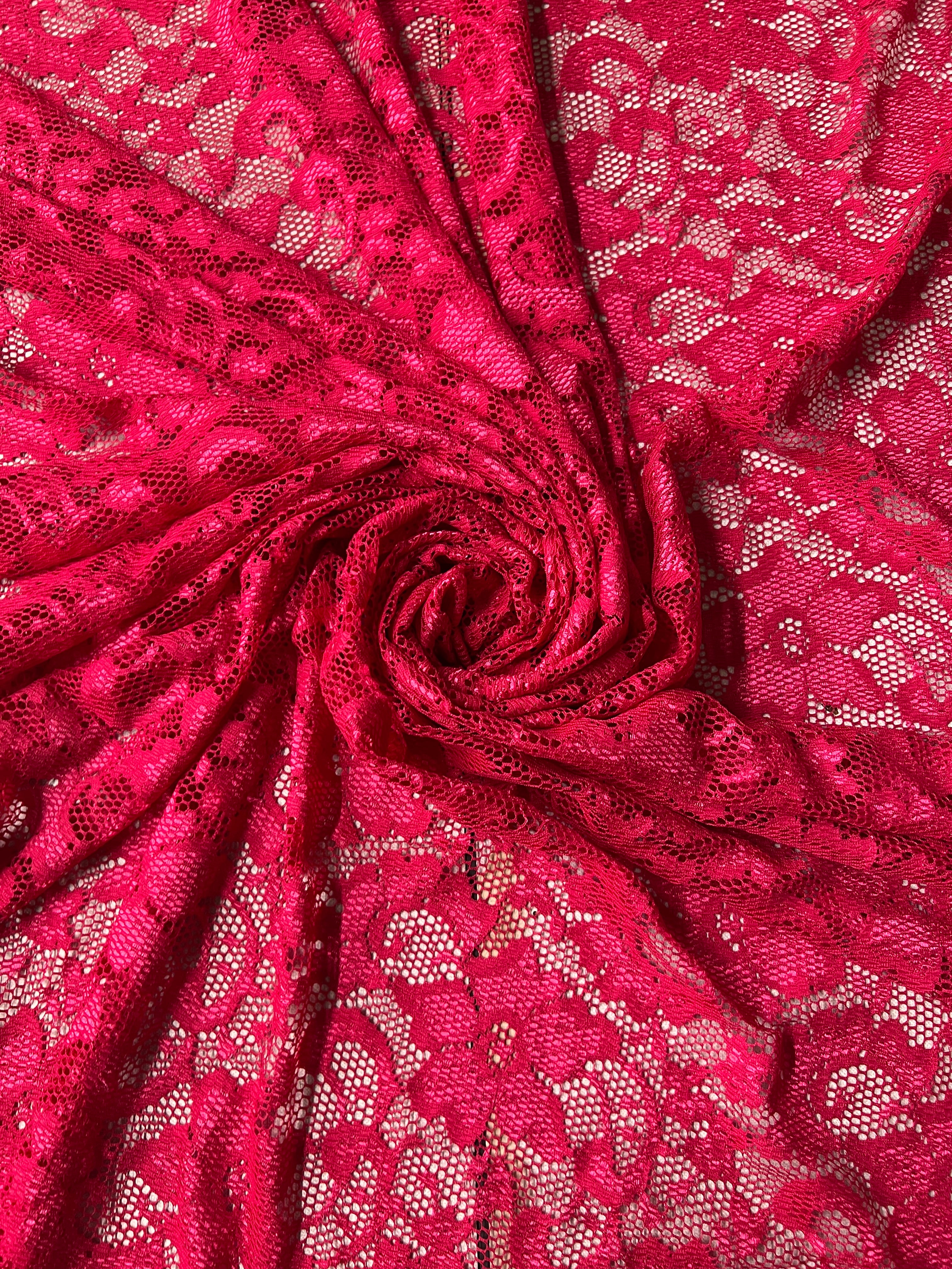Close-up of pink lace fabric with a subtle pattern
