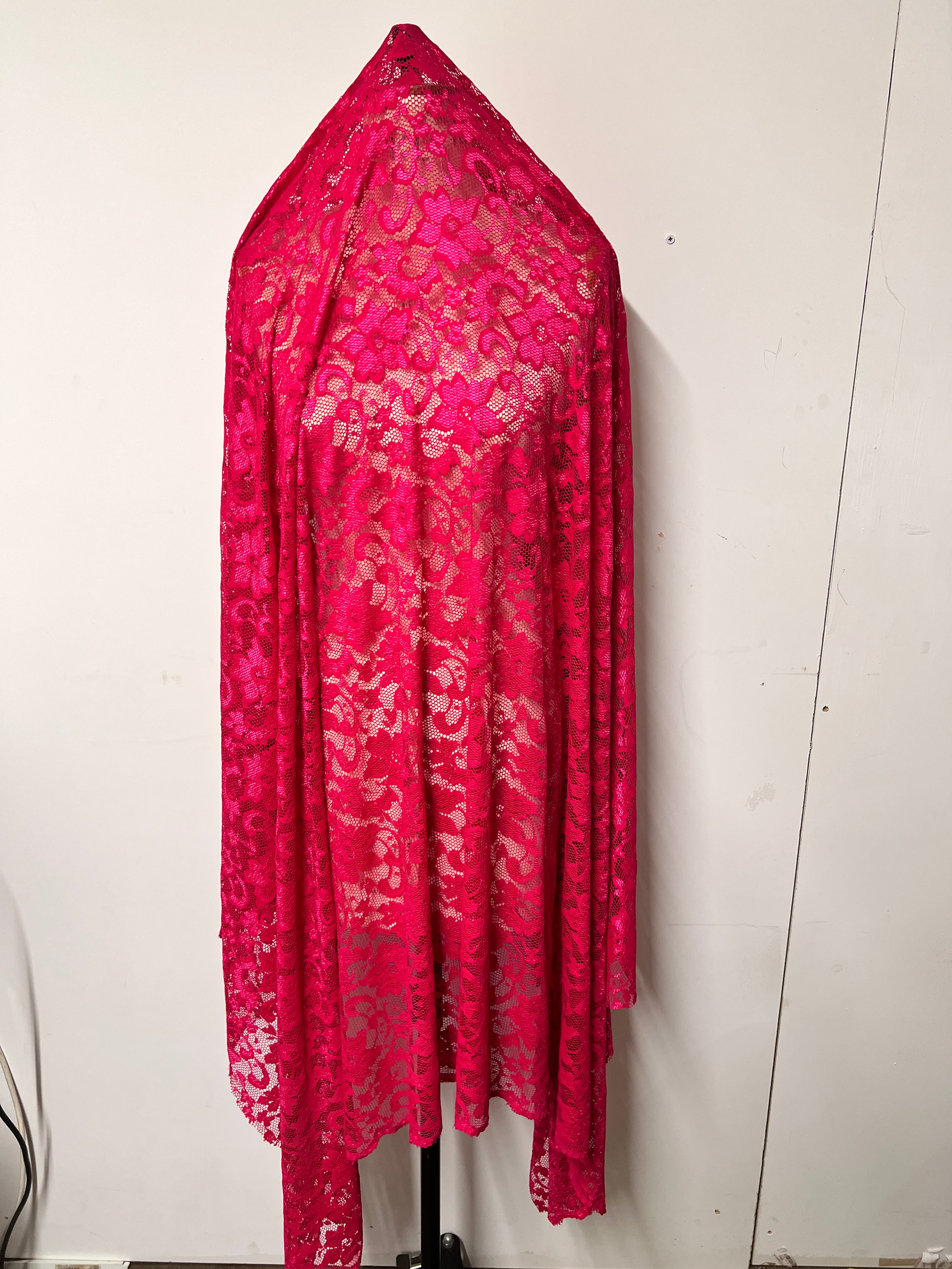 Pink floral fabric draped over a white surface