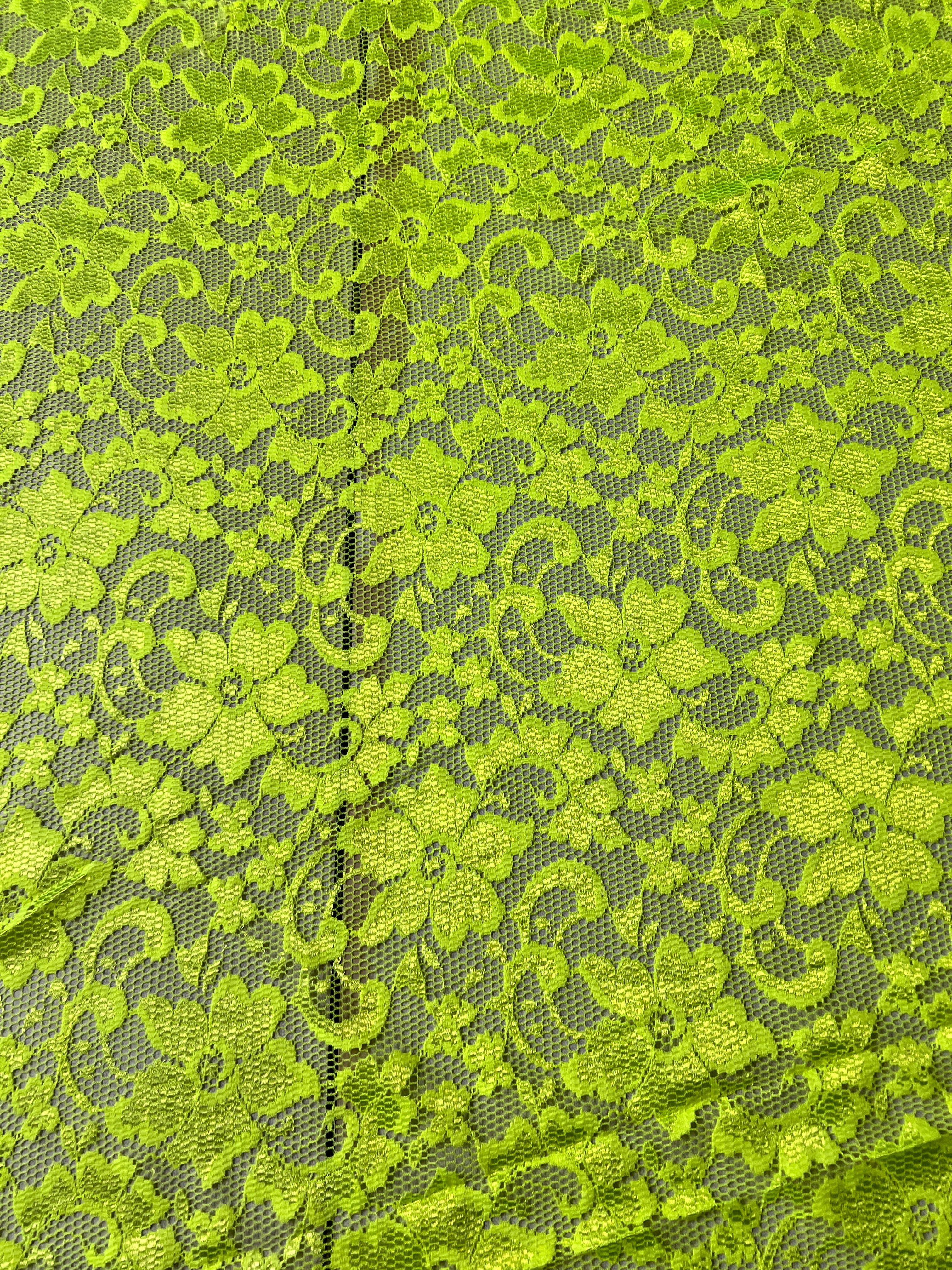 Green lace fabric with floral patterns