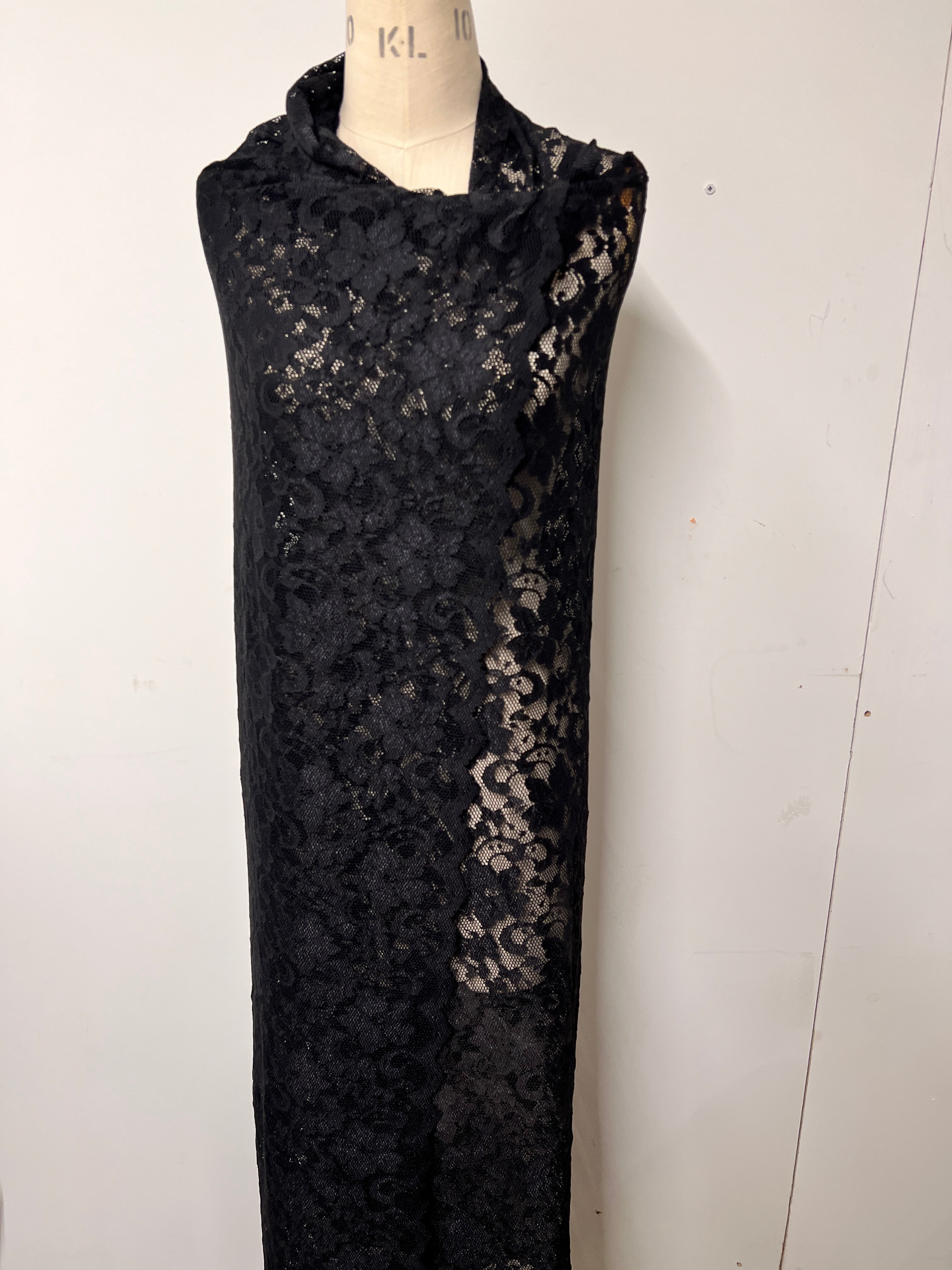 Black lace fabric on a white background
