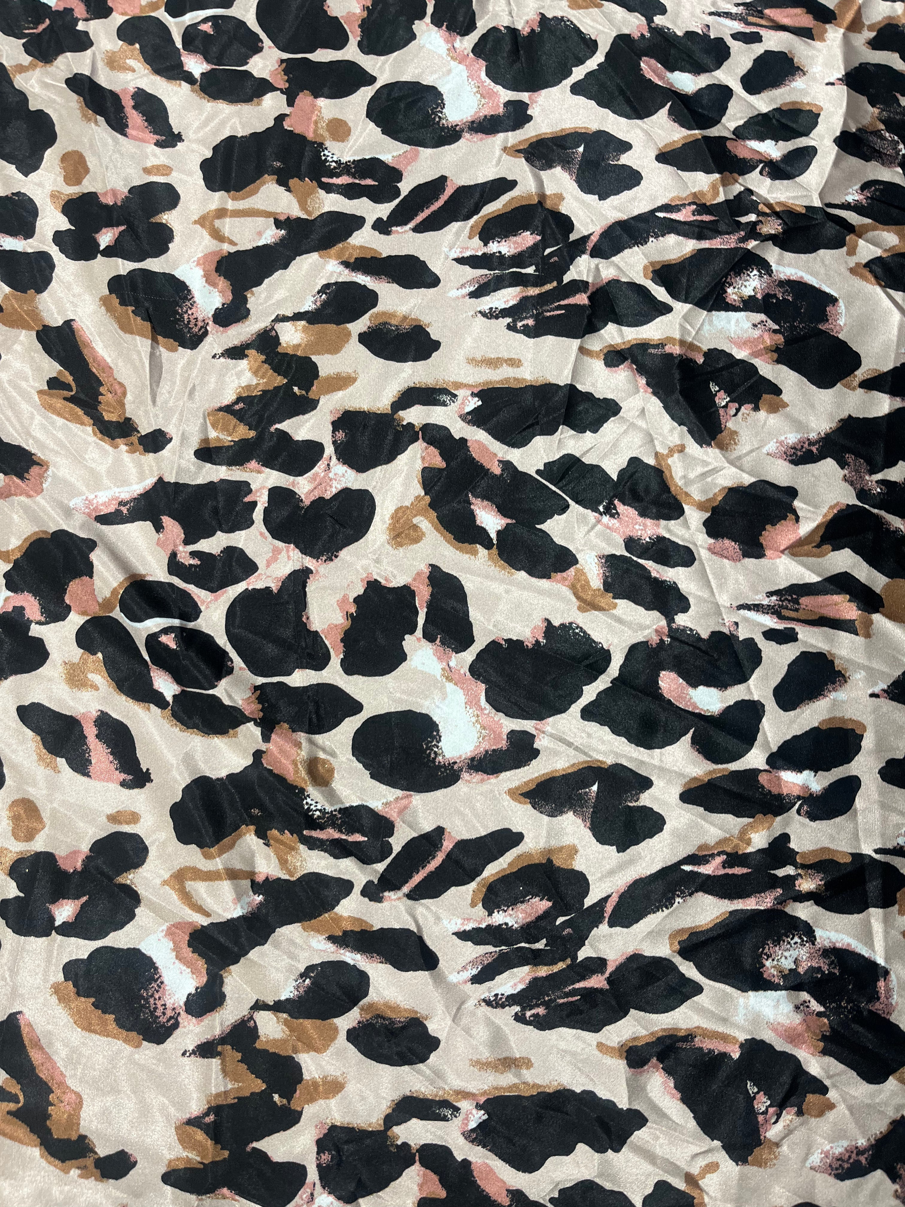 Leopard print pattern on a textured fabric background