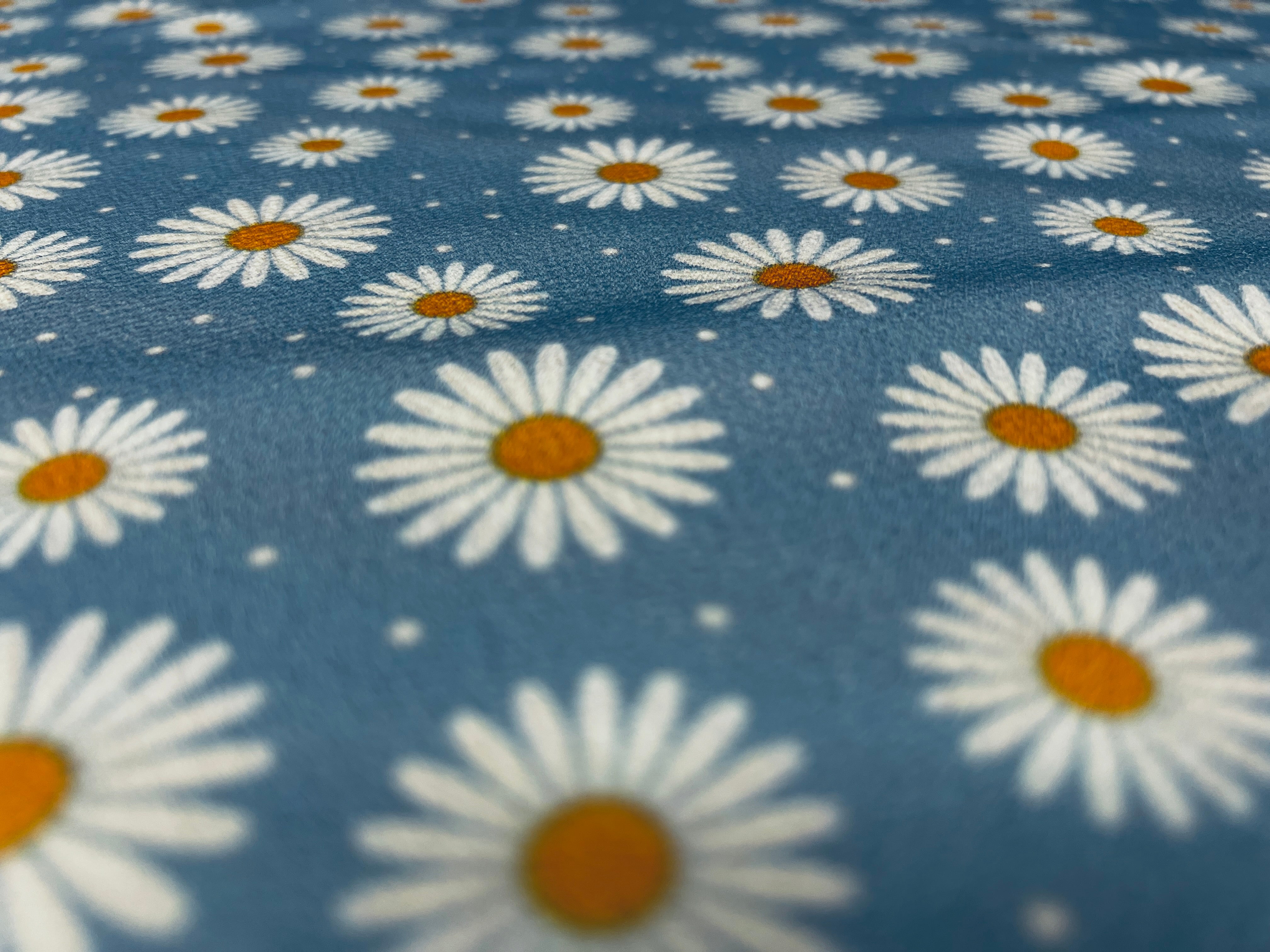 Vibrant blue daisy fabric for dressmaking projects.