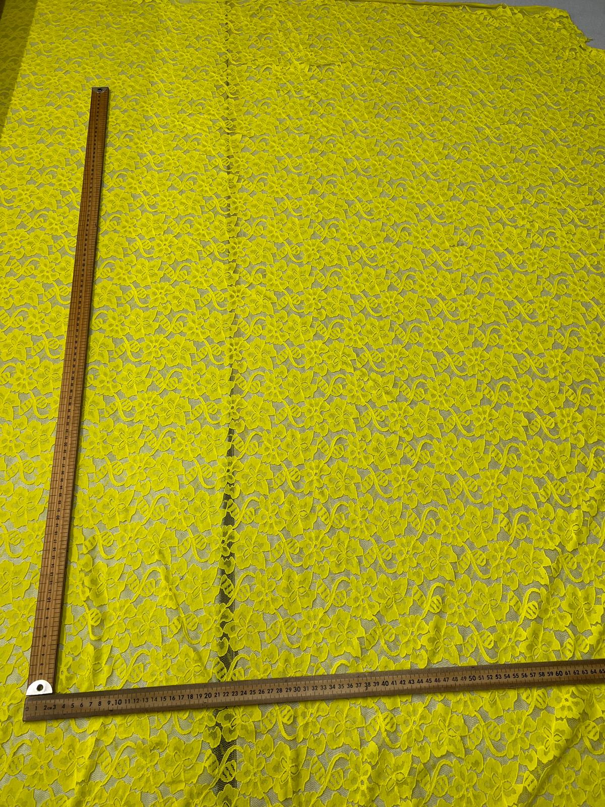 Yellow fabric with a floral pattern on a green background