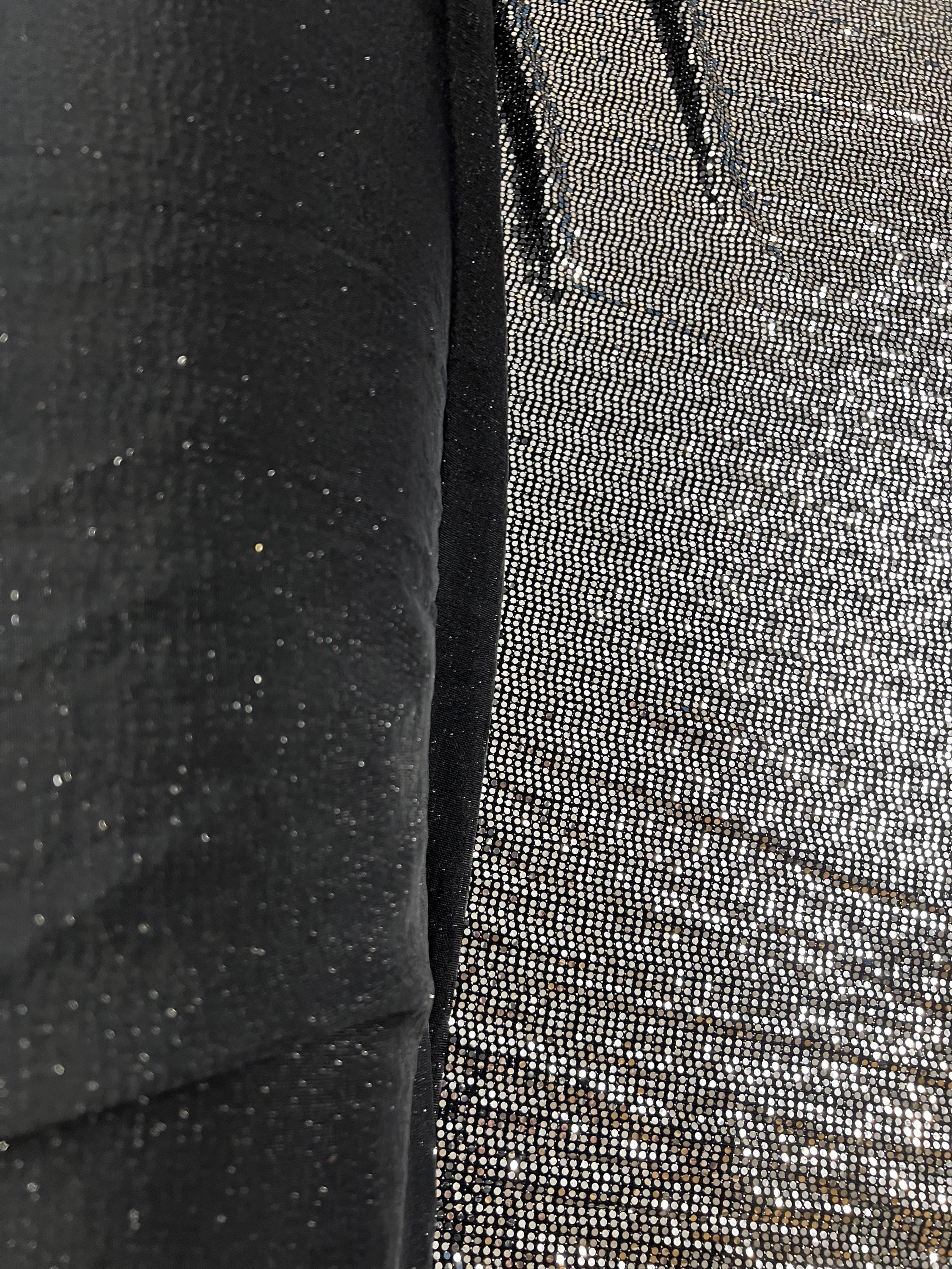 Shiny black silver foil dot stretch fabric on display