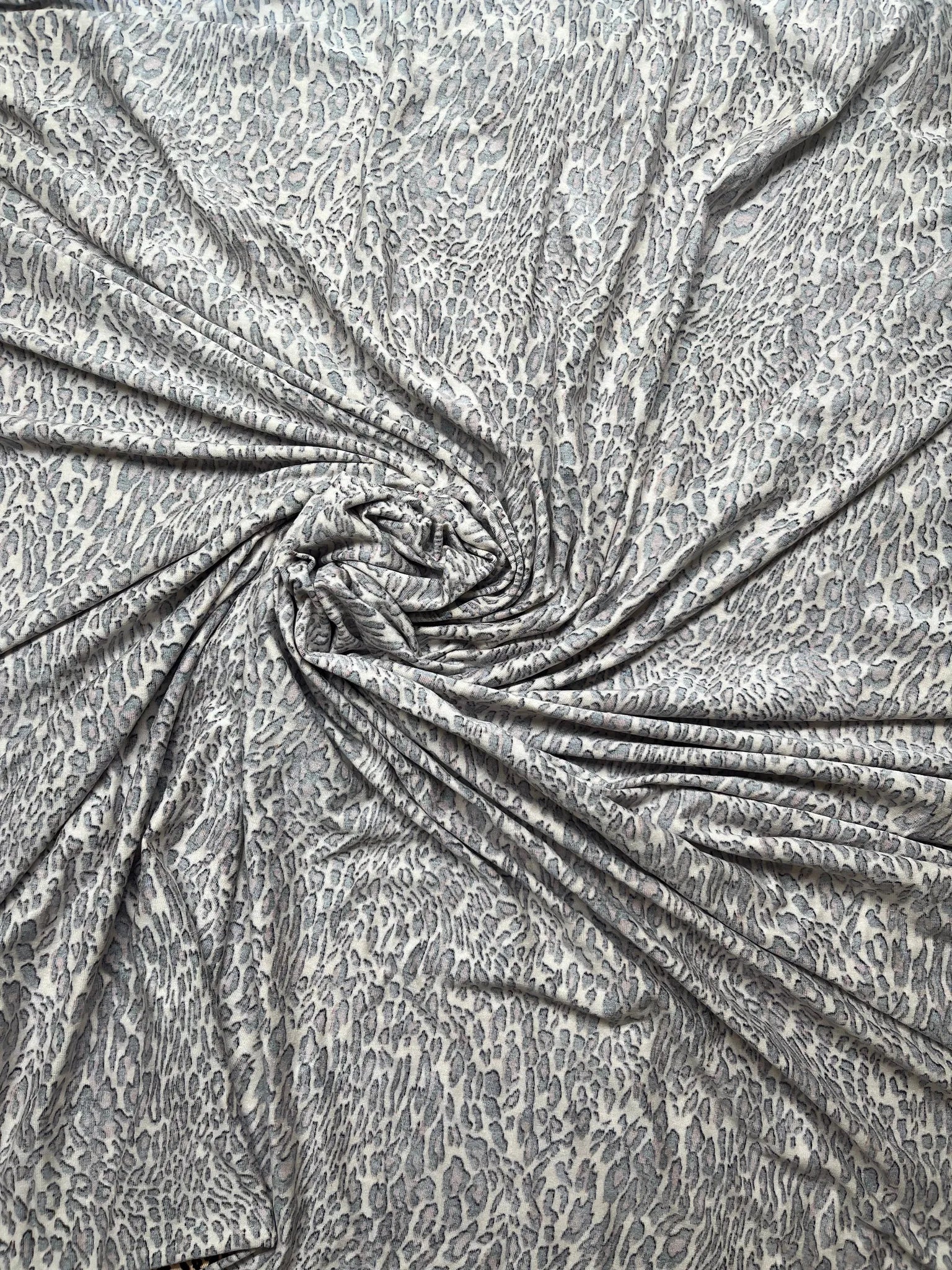 Animal print jersey fabric on a sewing machine ready for use.
