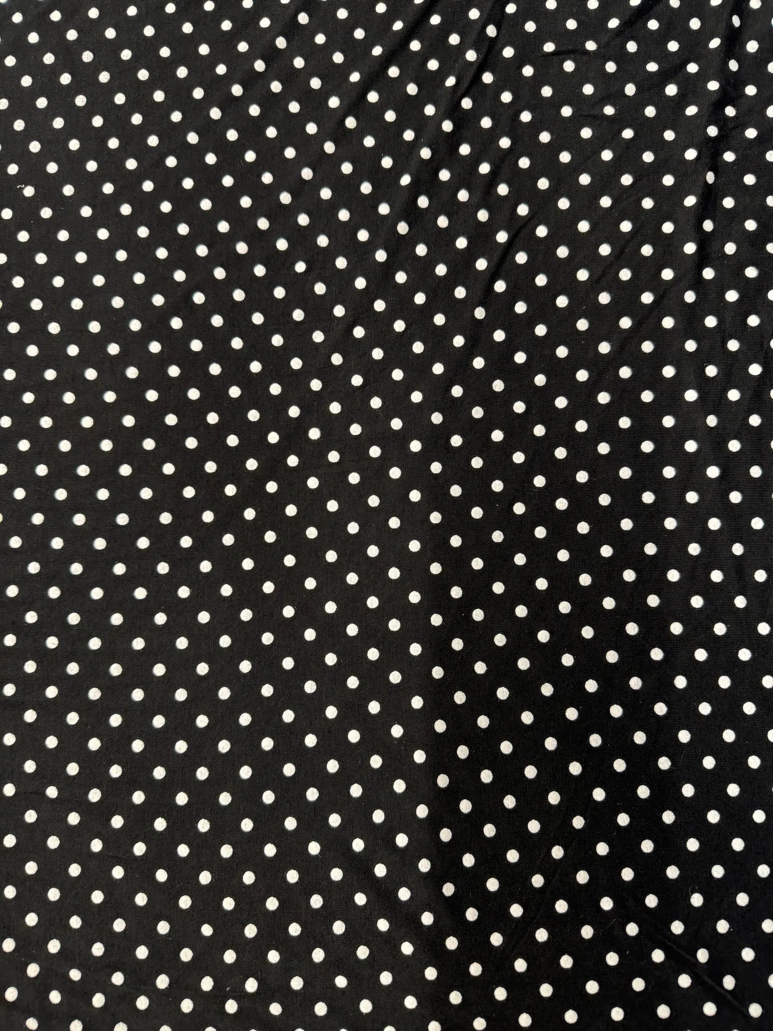 Close up of polka dot jersey fabric texture
