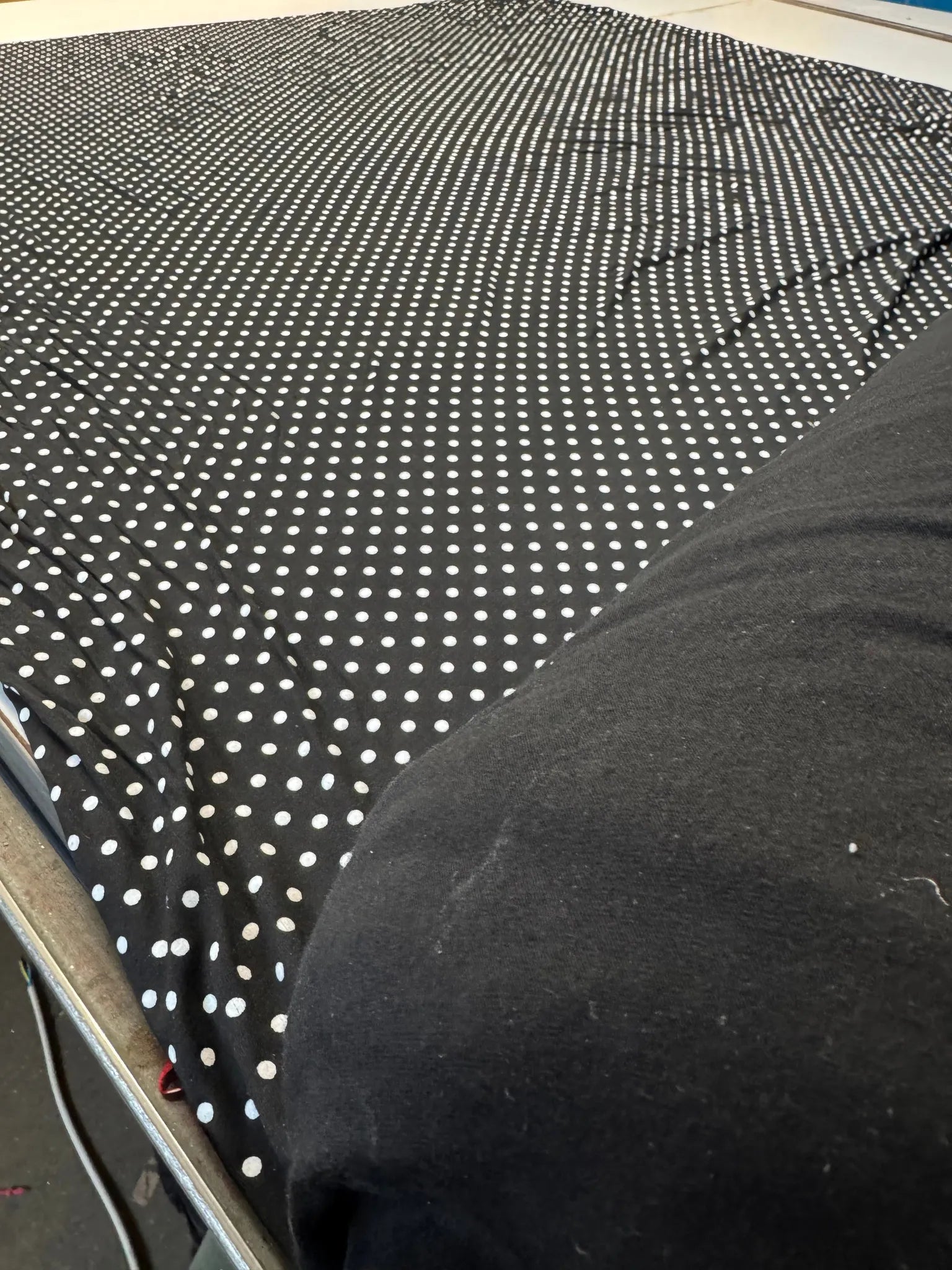 Soft and smooth polka dot jersey fabric draping