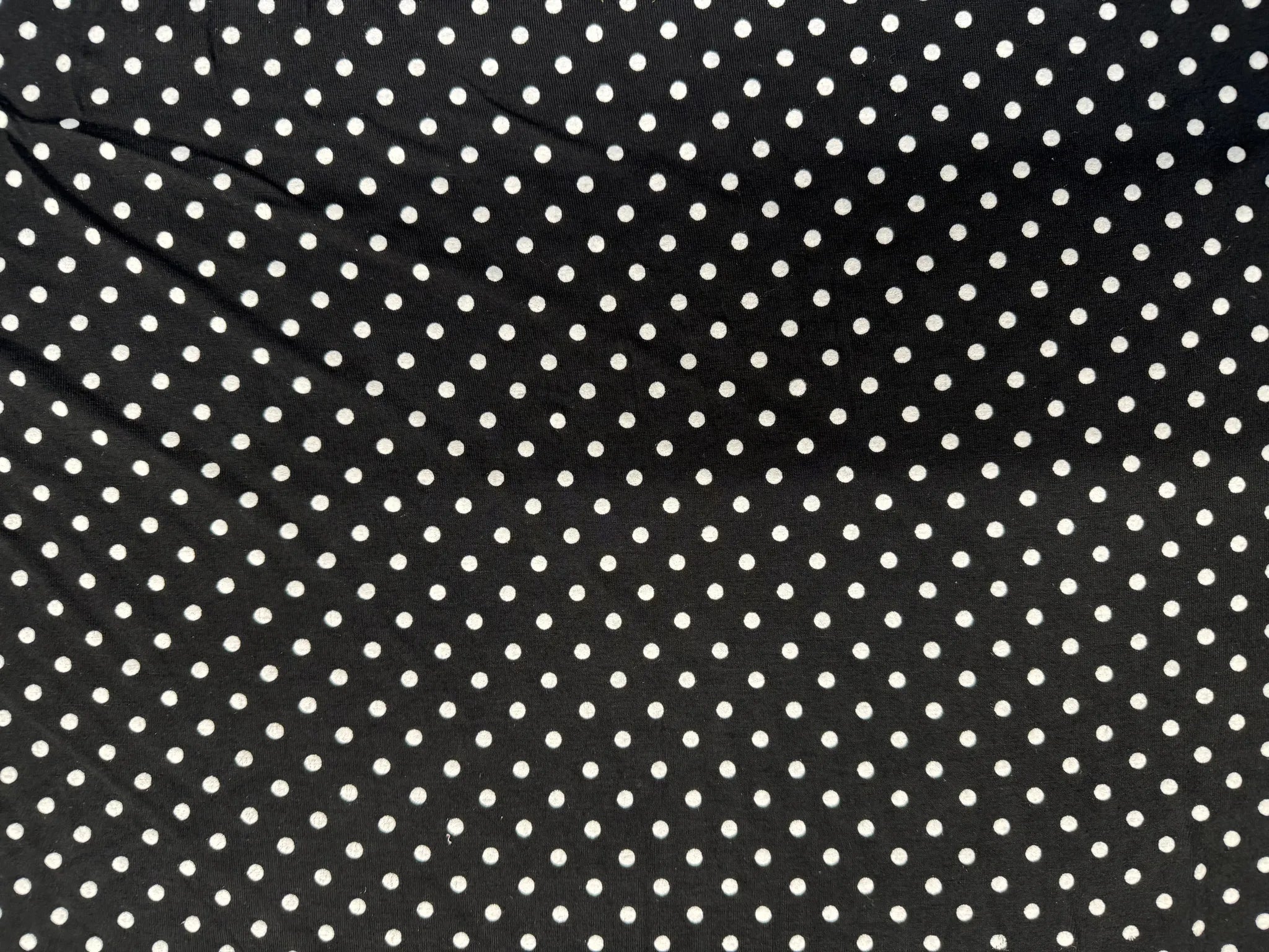 Black background with white polka dots fabric