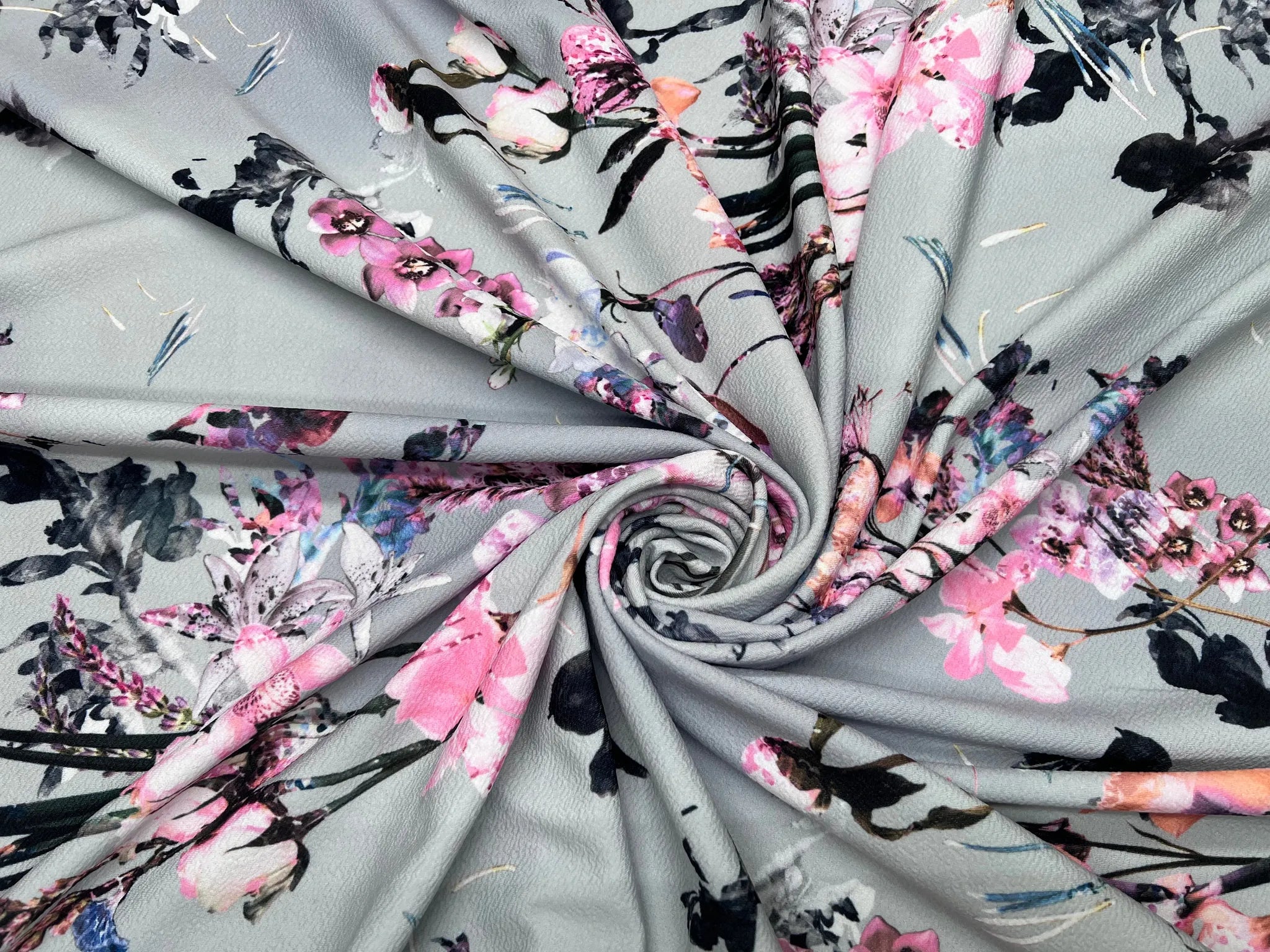 Close-up of grey floral pink watercolor Liverpool knit fabric