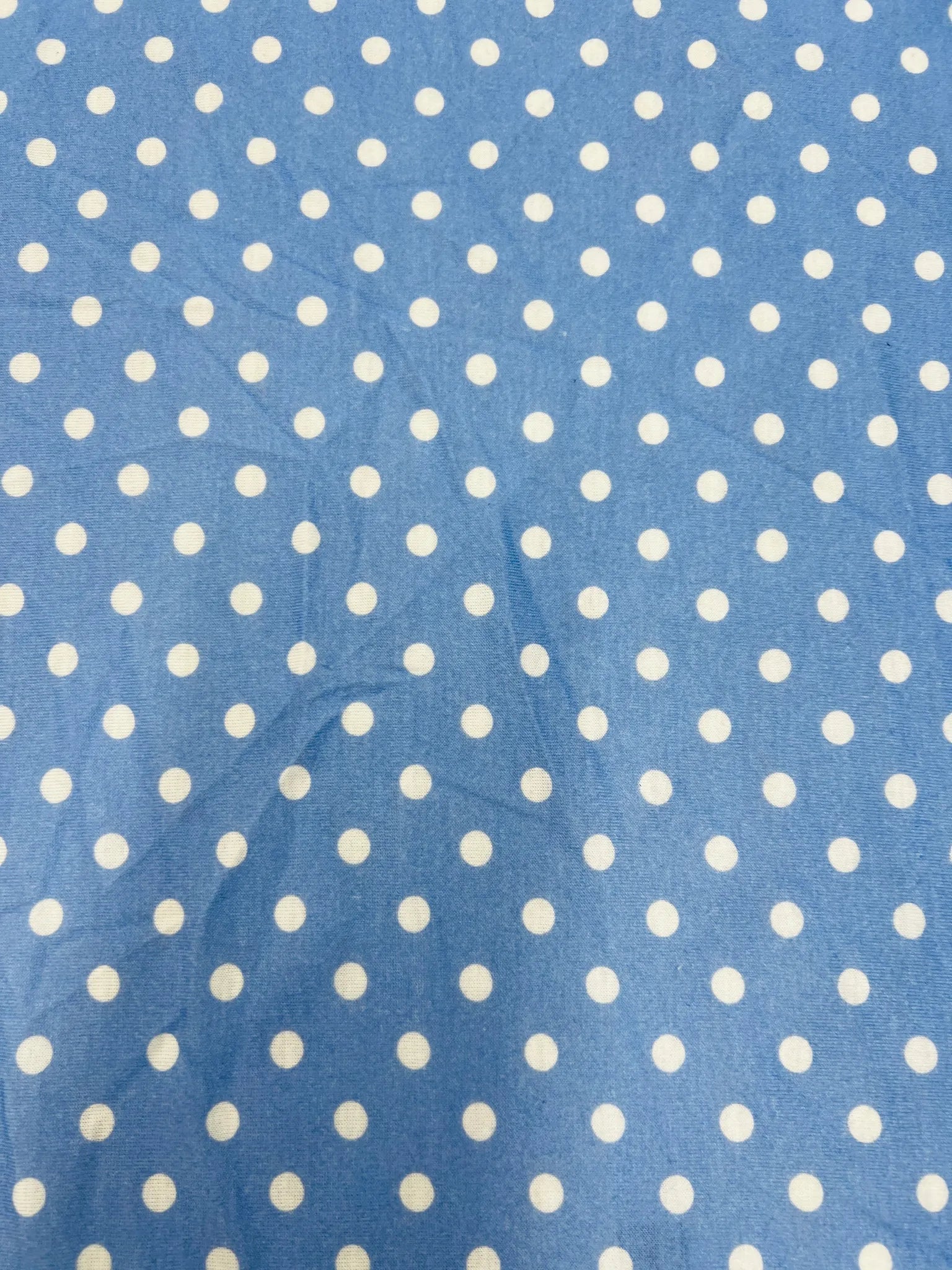 Smooth blue fabric with white polka dots