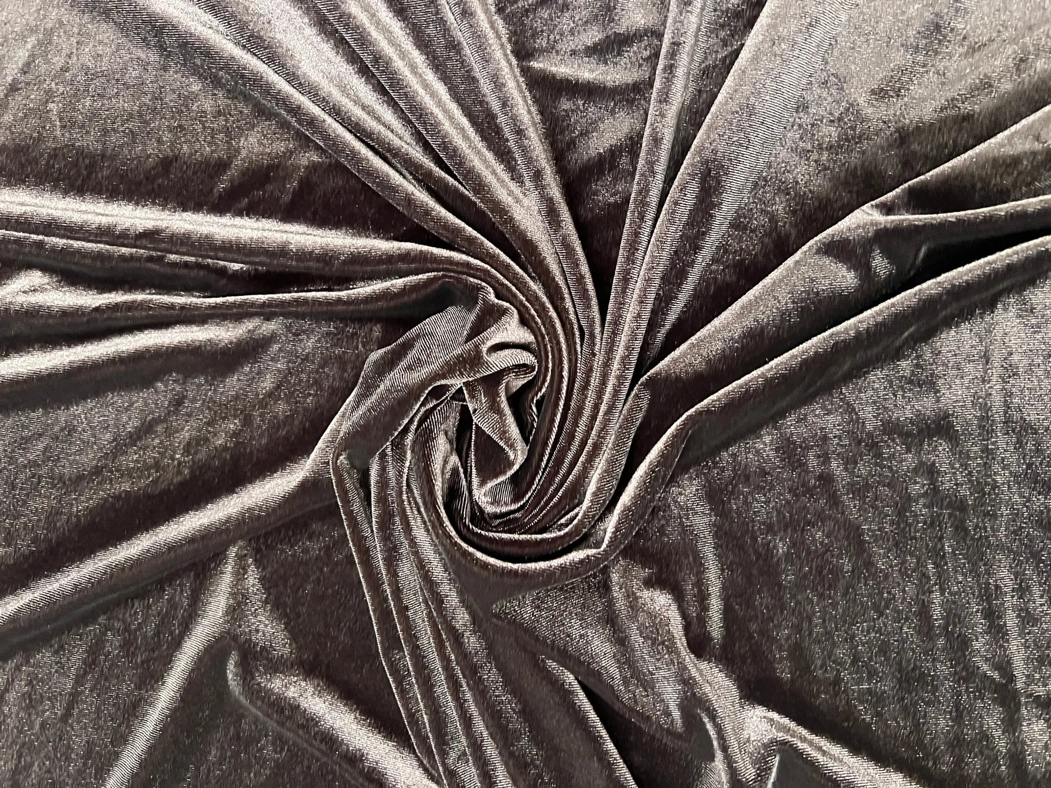 Luxurious chocolate brown stretch velvet fabric draping elegantly