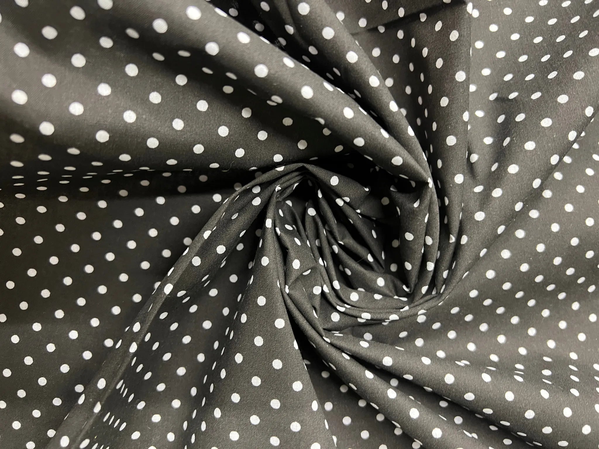 Classic black and white polka dot cotton fabric swatch for sewing
