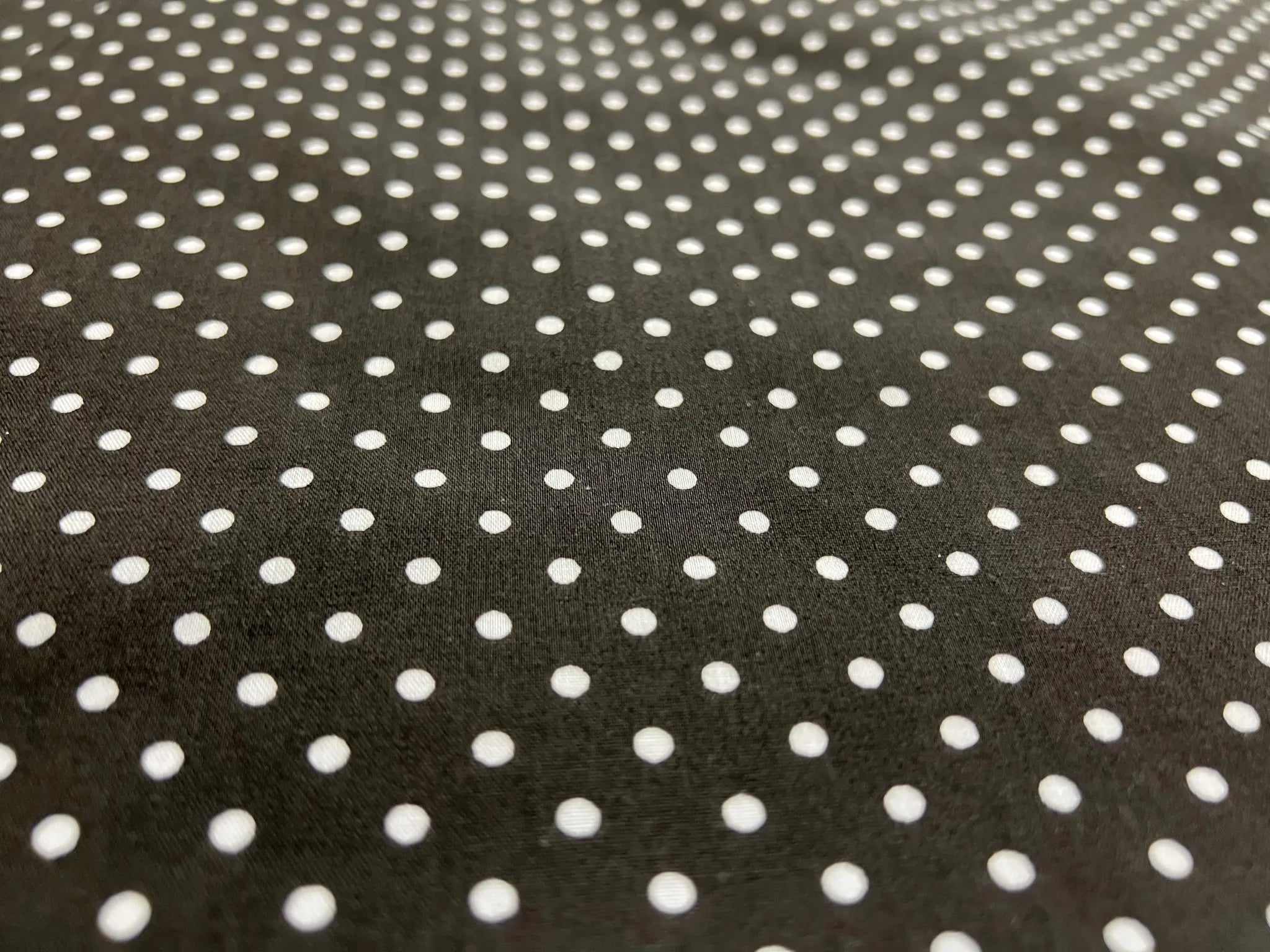 Polka dot cotton fabric draped for dressmaking projects