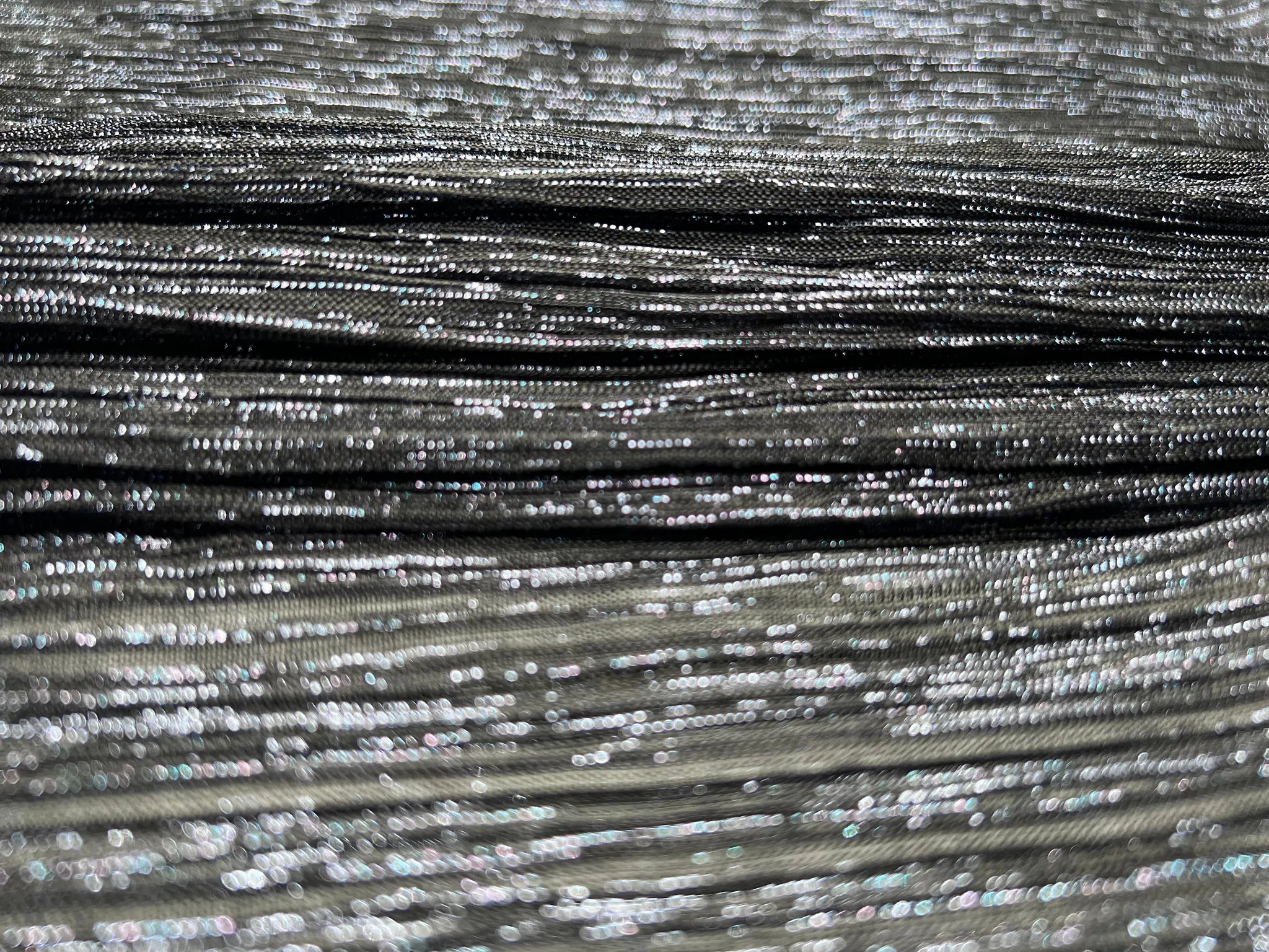 Close-up of black plisse jersey showcasing its soft sheen