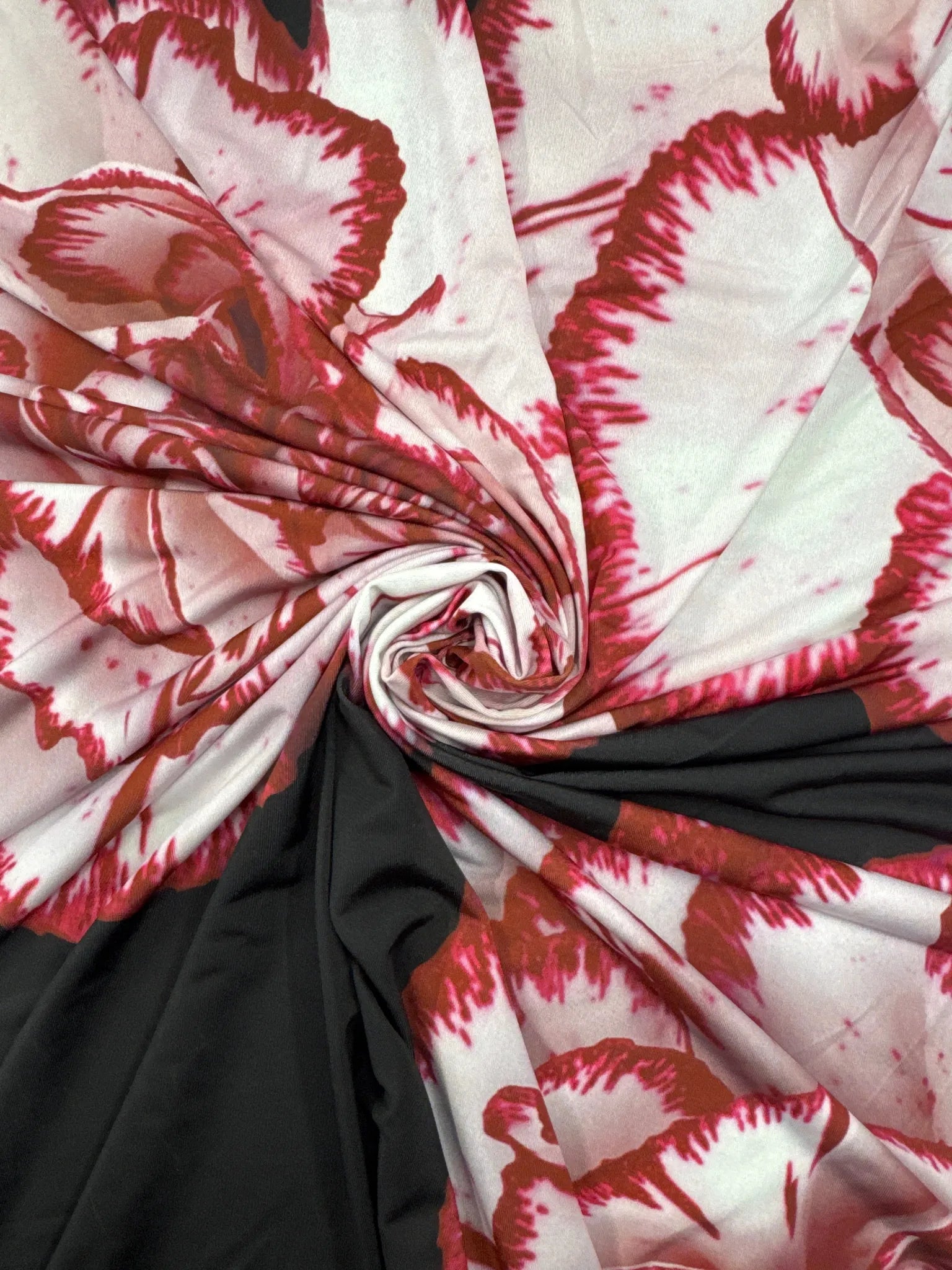Luxurious black and red floral slinky jersey fabric close-up