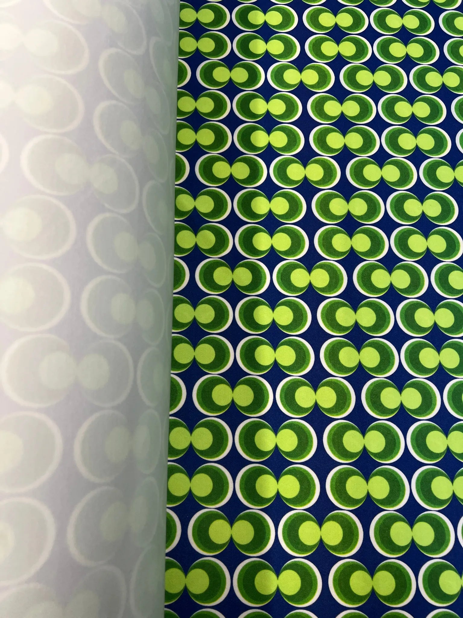 Vibrant blue and green scuba crepe fabric with geometric design