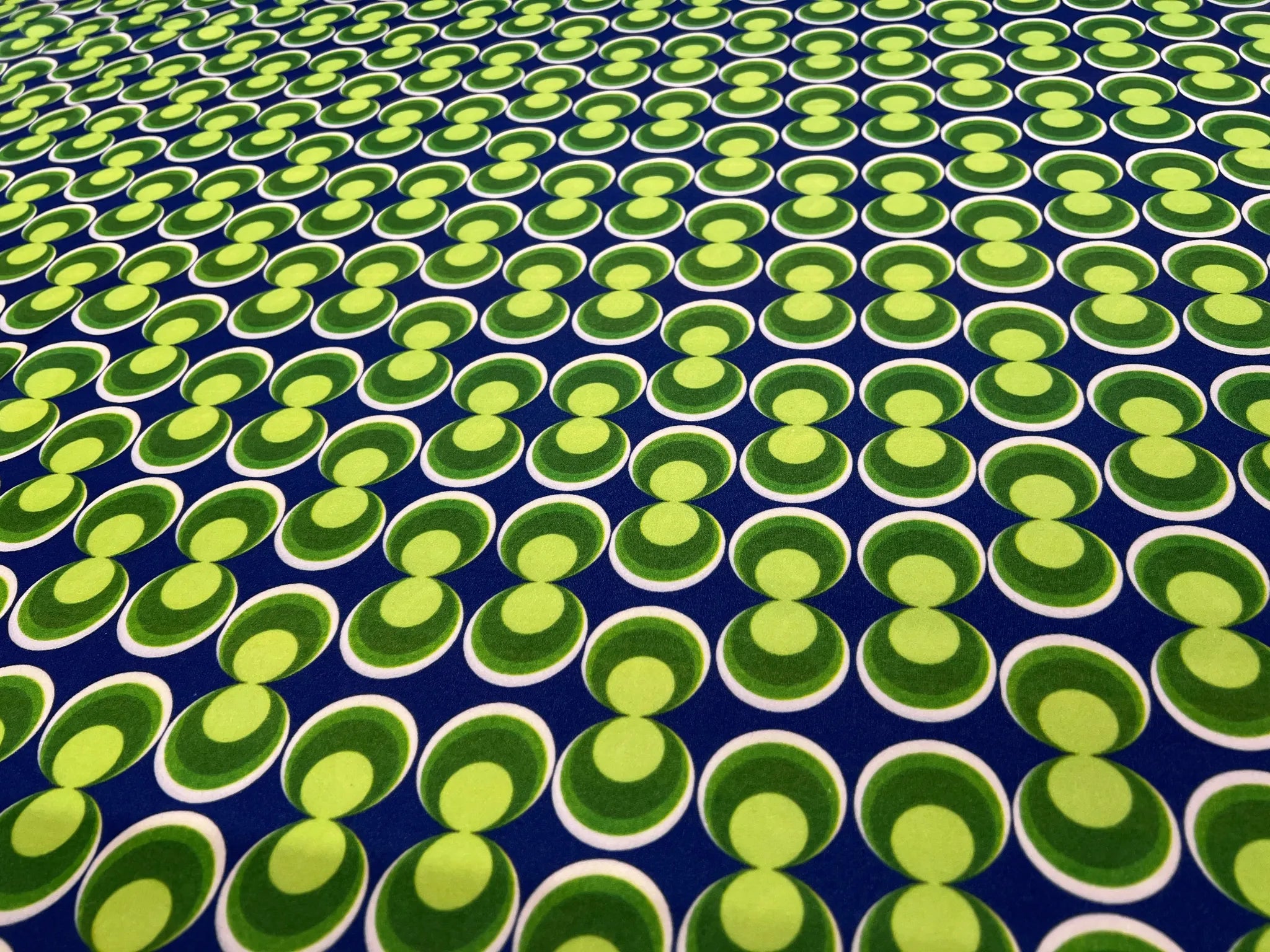 Folding retro geometric scuba crepe fabric showcasing texture
