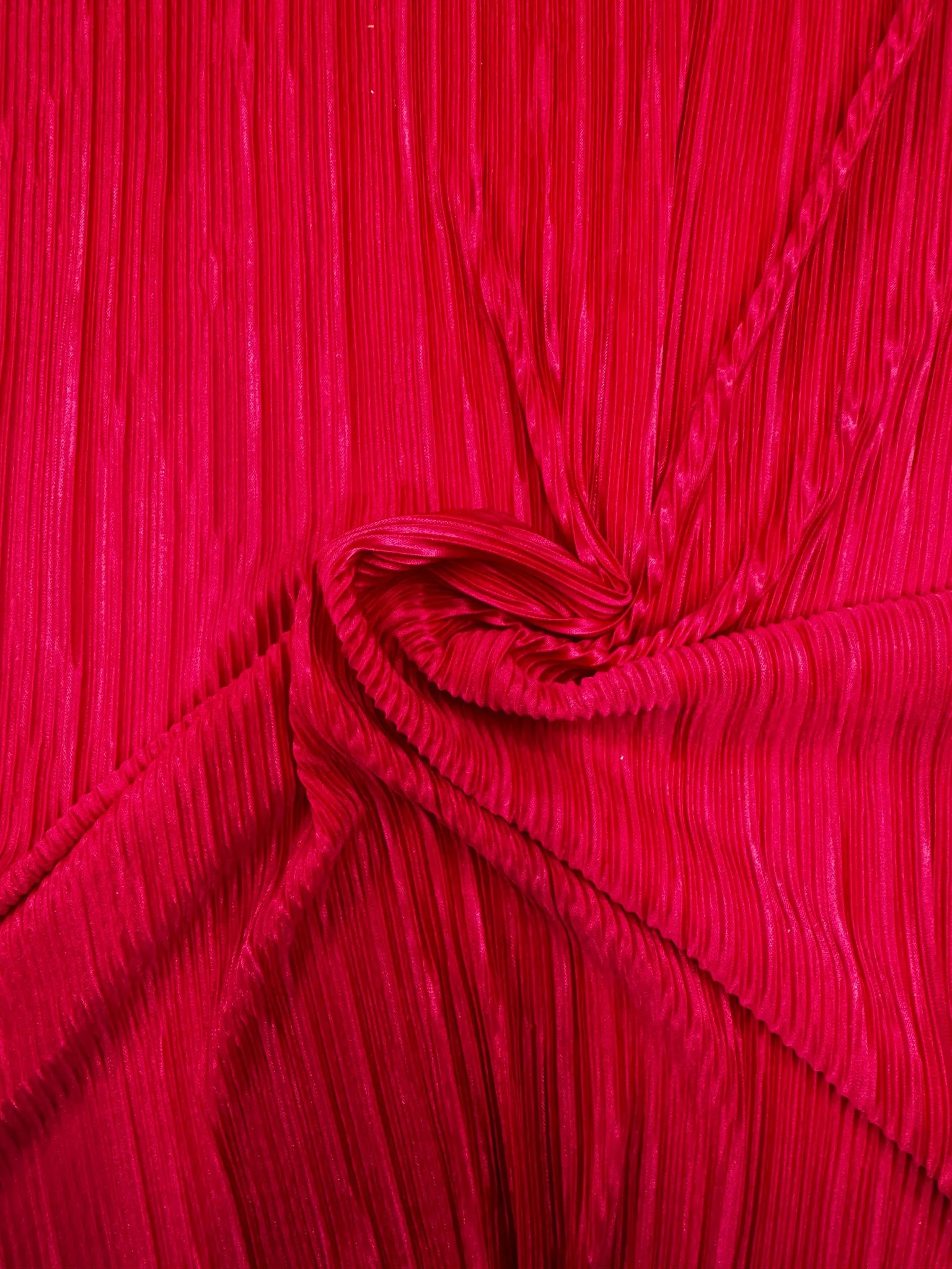 Vibrant hot pink plissé pleated fabric with fine vertical pleats