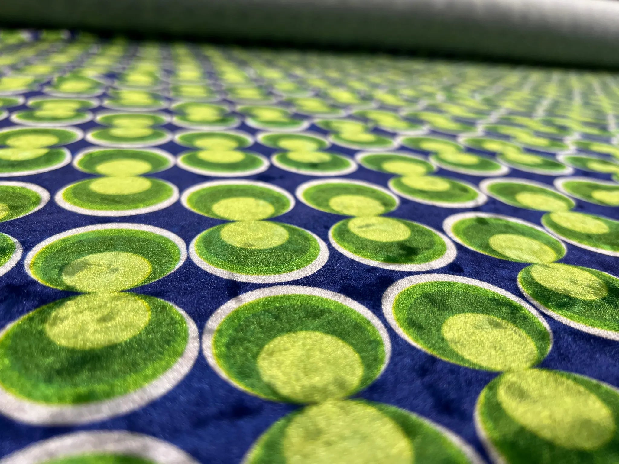 Flowing drape of blue and green stretch velvet fabric