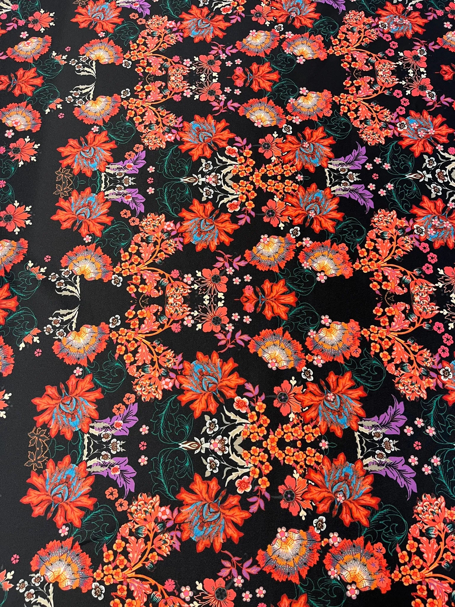 Roll of black floral scuba fabric perfect for sewing