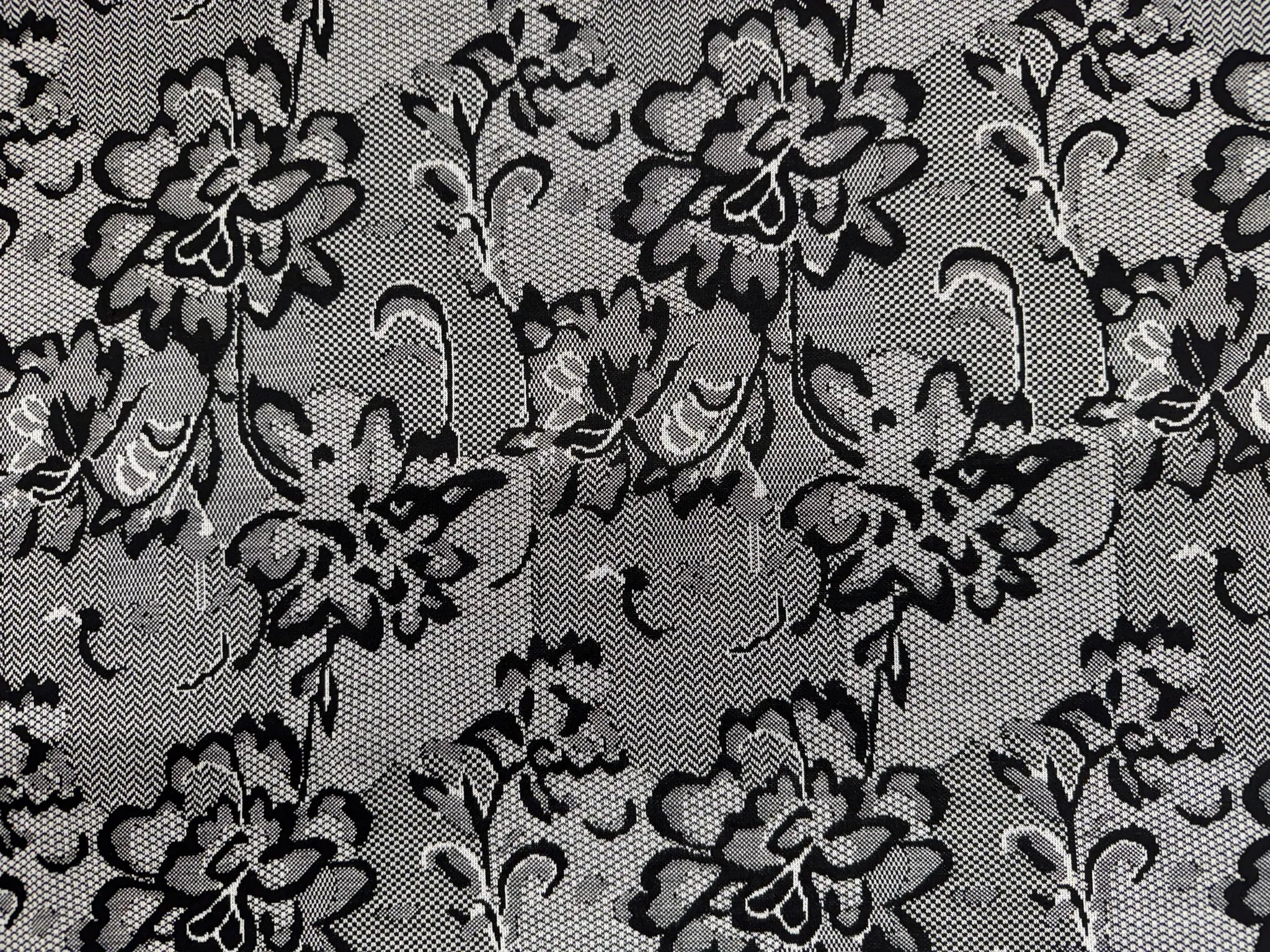 Designer showcasing a garment made from lace print jersey fabric