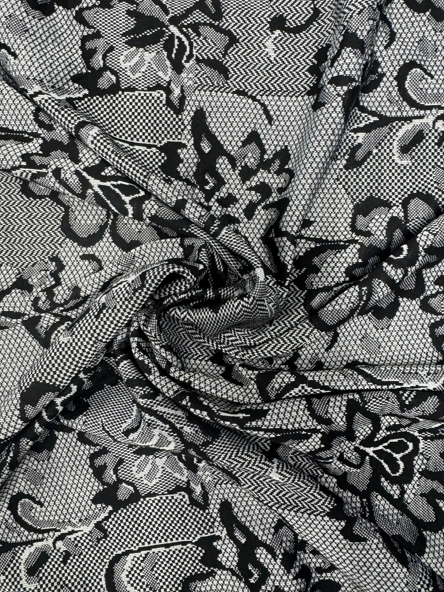 Beautiful drape of black and white textured lace print jersey