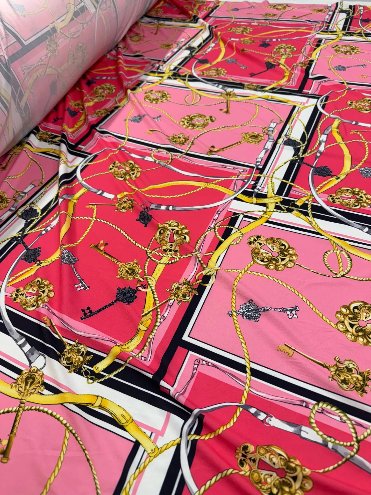 Close-up of Pink Red Gold Chain Key Print Fabric texture