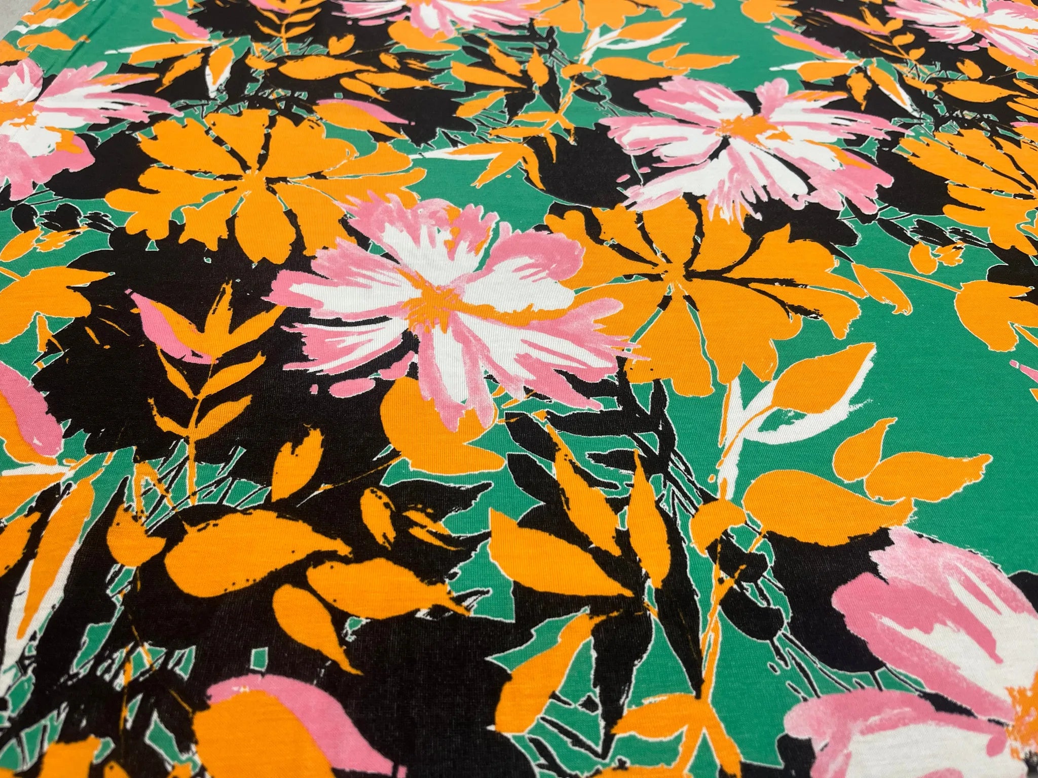 Vibrant green floral fabric ideal for dressmaking